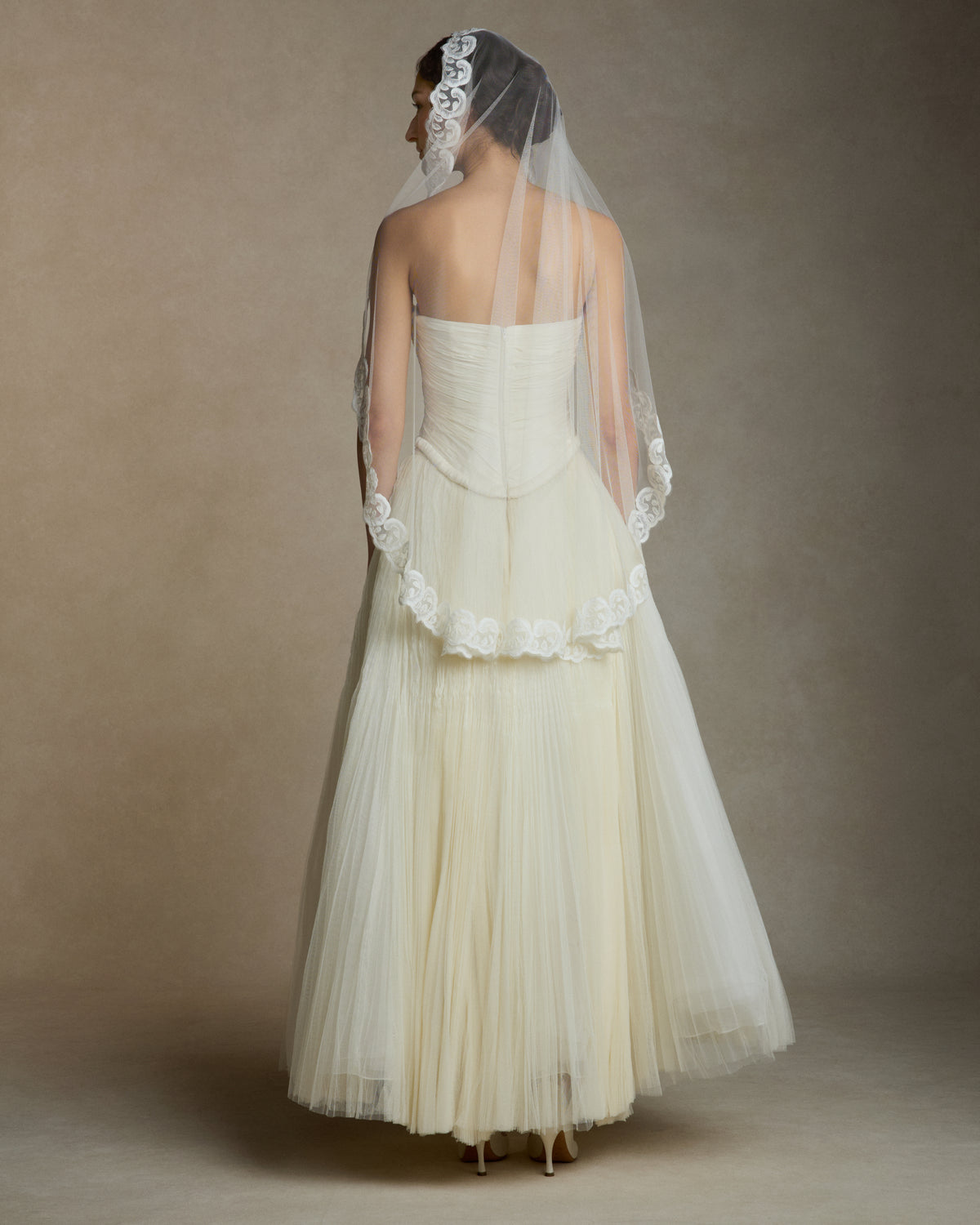 Soft tulle veil trimmed with thread embroidered wave detail. 45” from comb.