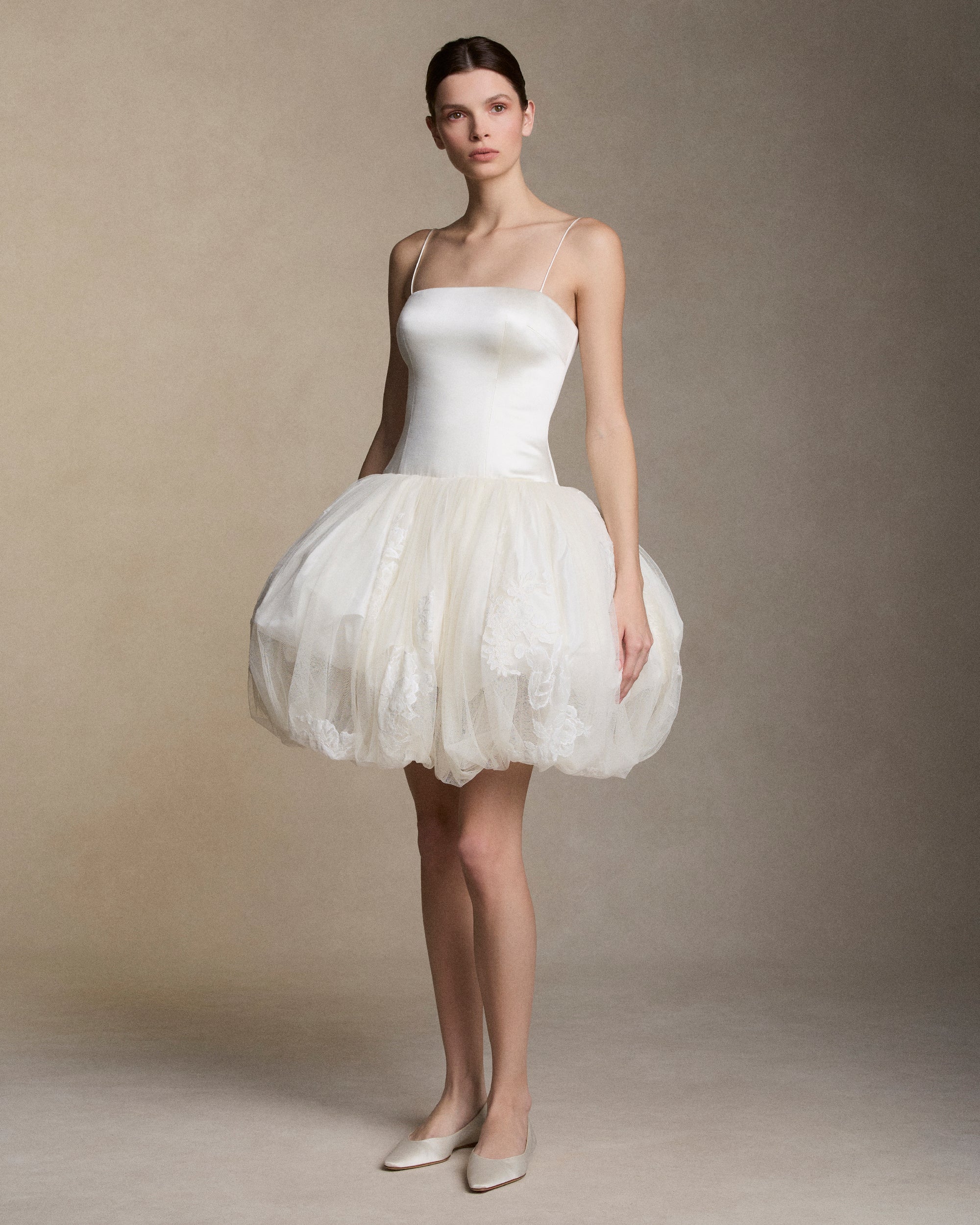 Silk wool drop waist mini dress with layered silk taffeta and soft tulle  bubble skirt adorned with hand cut chantilly and lace appliques. Straight neckline with spaghetti straps. Boned internal bustier, internal grosgrain belt and invisible zip closure at center back.