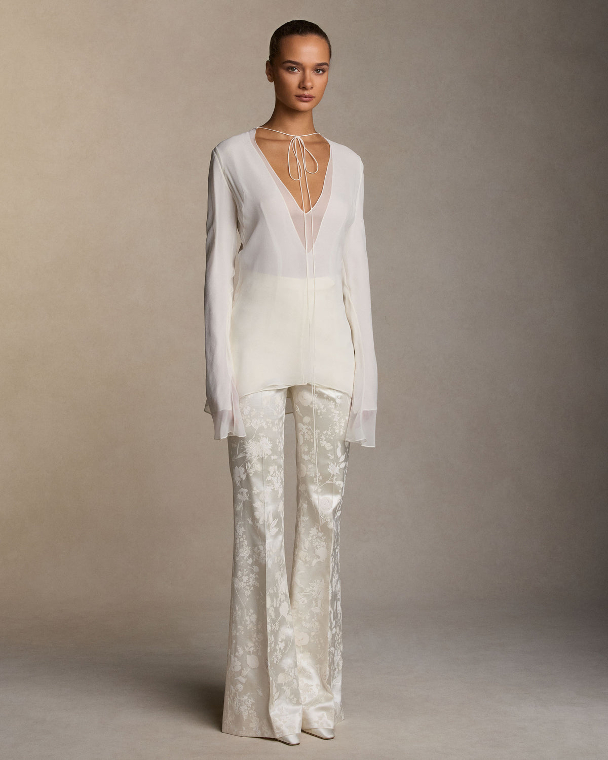 Pigment printed and hand painted silk wool bootcut trousers with a sharp pressed crease. Front fly zip closure with hook-and-bar fastening.Styled with Samira top