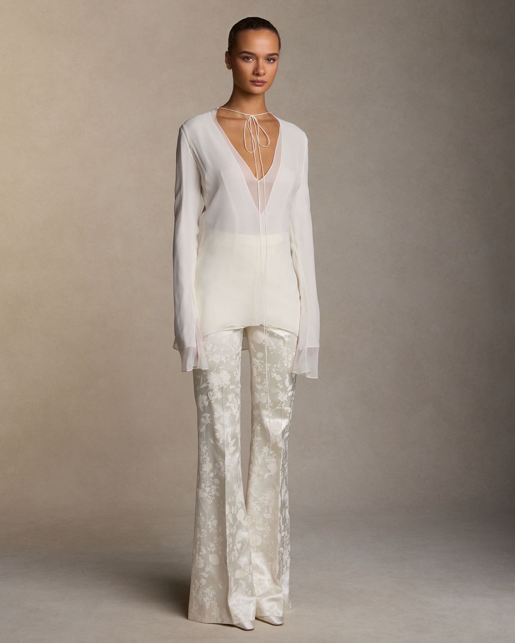 Pigment printed and hand painted silk wool bootcut trousers with a sharp pressed crease. Front fly zip closure with hook-and-bar fastening.Styled with Samira top