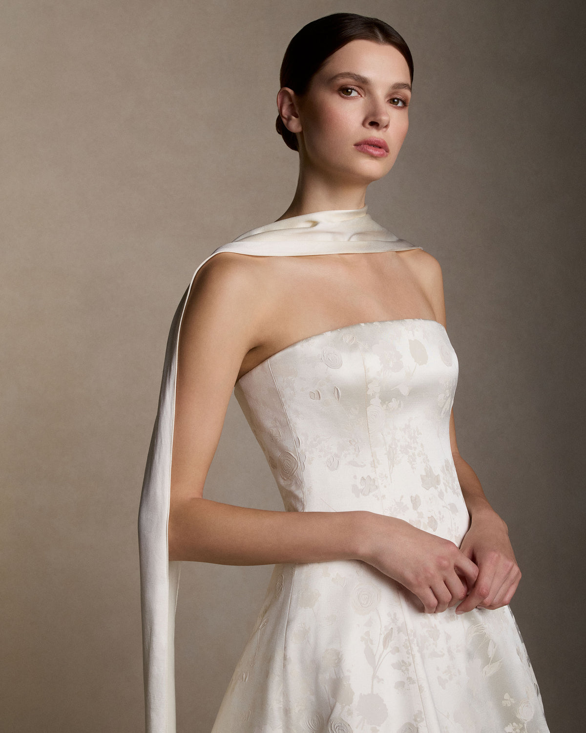 Strapless ball gown cut in pigment printed and hand painted silk wool. Boned internal bustier with internal grosgrain waistbelt and  invisible zip closure at center back. Styled with Mirielle topper and Silk Wool Scarf