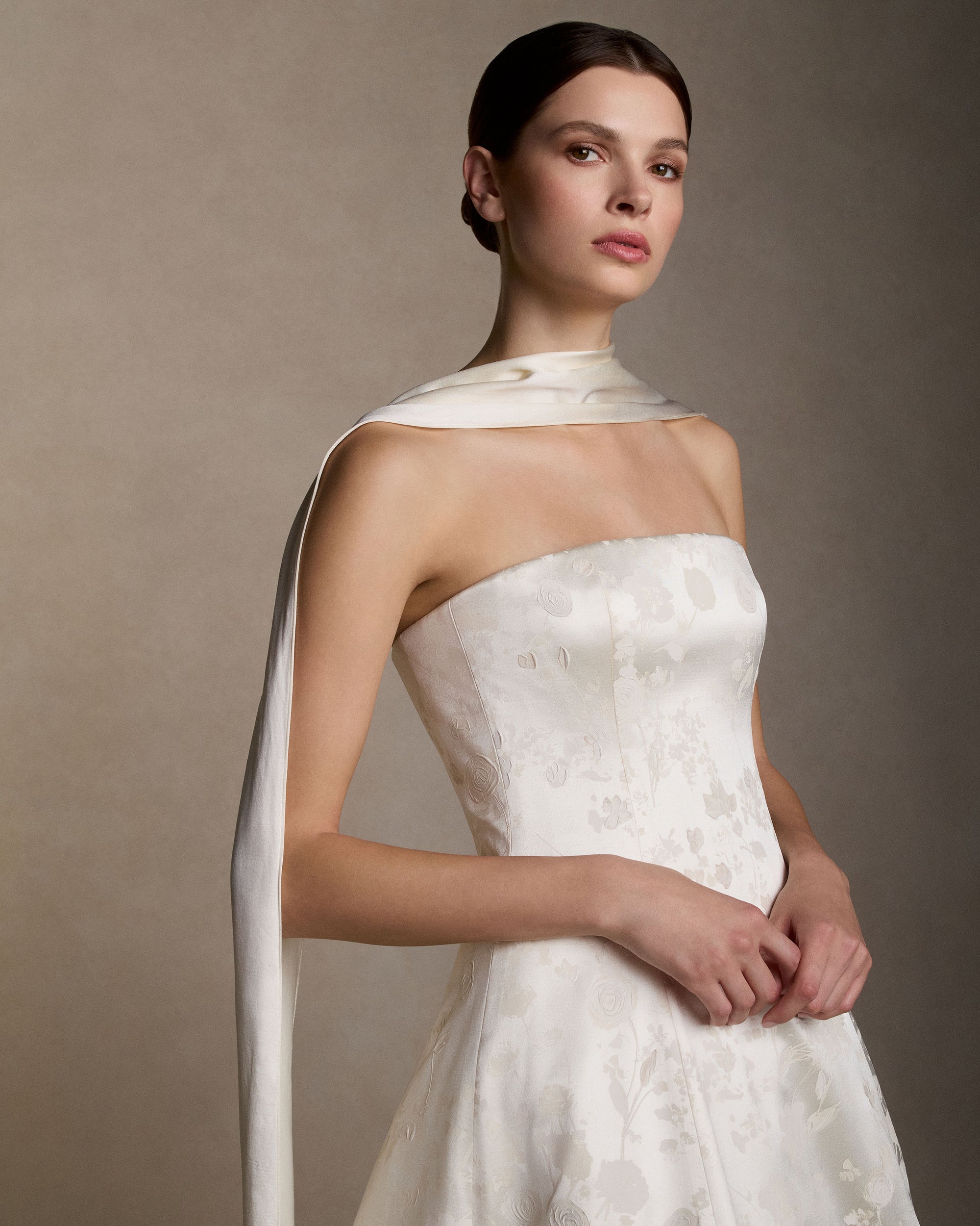 Strapless ball gown cut in pigment printed and hand painted silk wool. Boned internal bustier with internal grosgrain waistbelt and  invisible zip closure at center back. Styled with Mirielle topper and Silk Wool Scarf