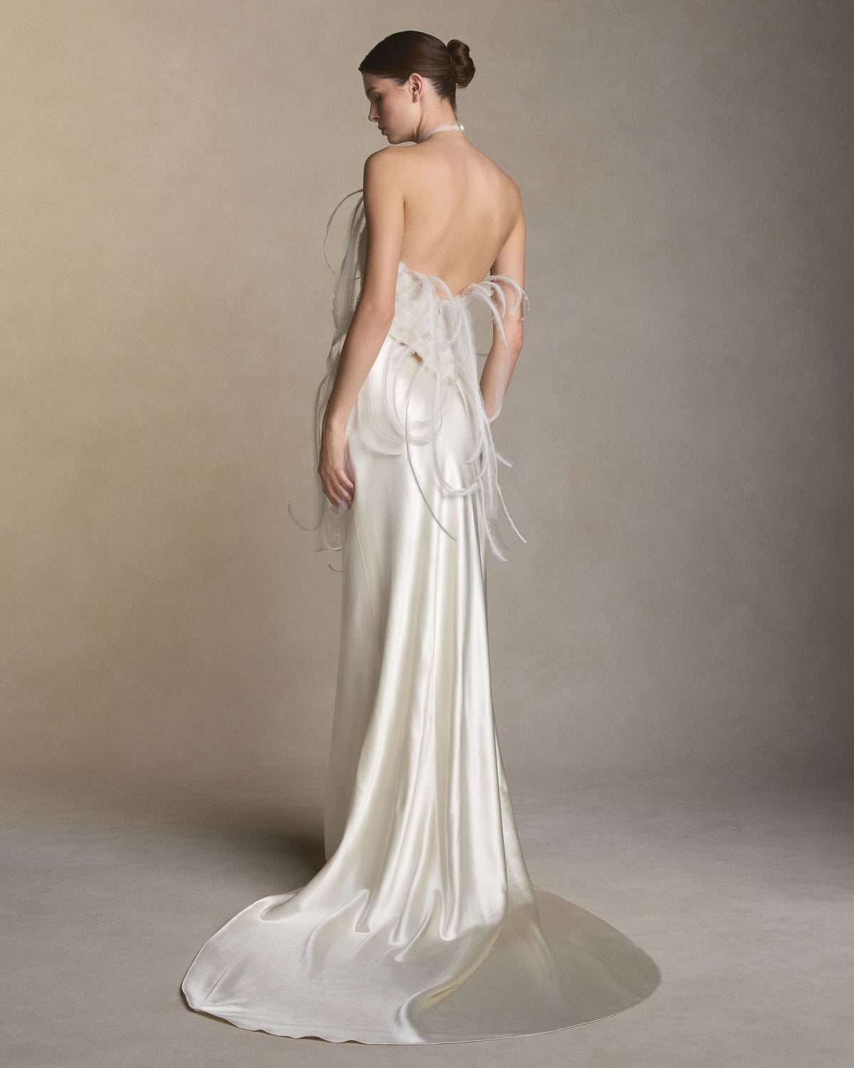 Silk organza embroidered halter top. Frayed silk organza layered over horsehair creates a textural woven fabric, releasing into undulating fringe at the neckline and waistline. Corded lace and silk chiffon are layered beneath to create dimension. Invisible center back zip. Styled with Dree skirt