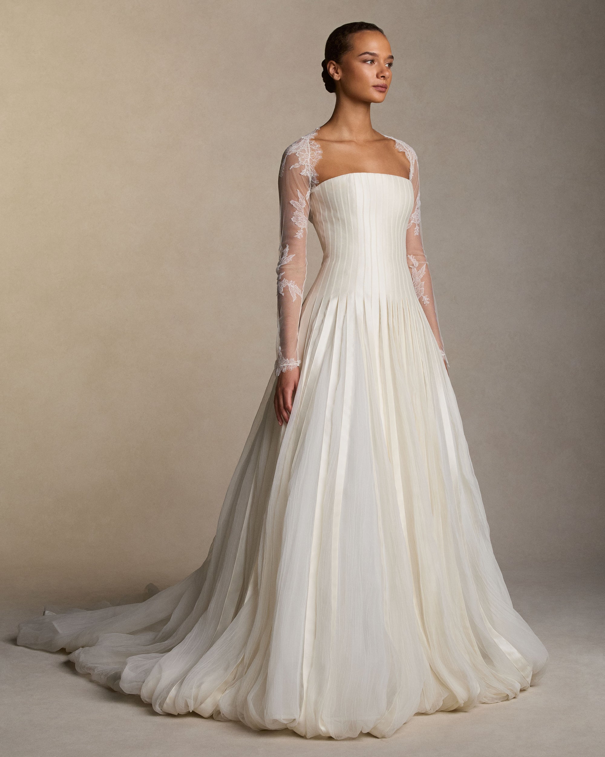 Tulle long sleeve bolero with hand cut chantilly lace appliques and scalloped border detail.Styled with Audrey gown