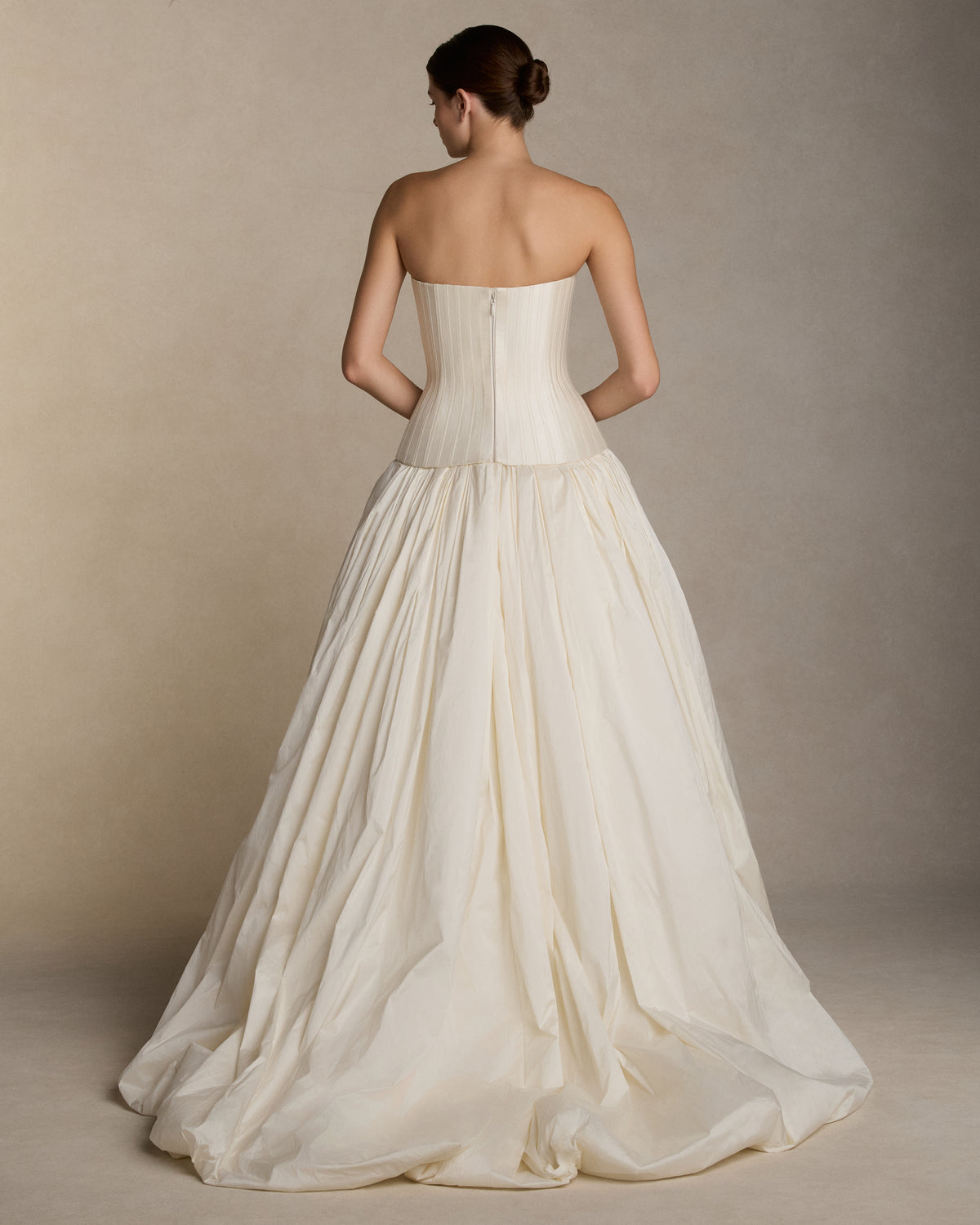Dramatic tissue taffeta ball skirt with basque waist yoke and bubble hem. Invisible zip closure at center back.Styled with Veda Silk Wool Twill bustier