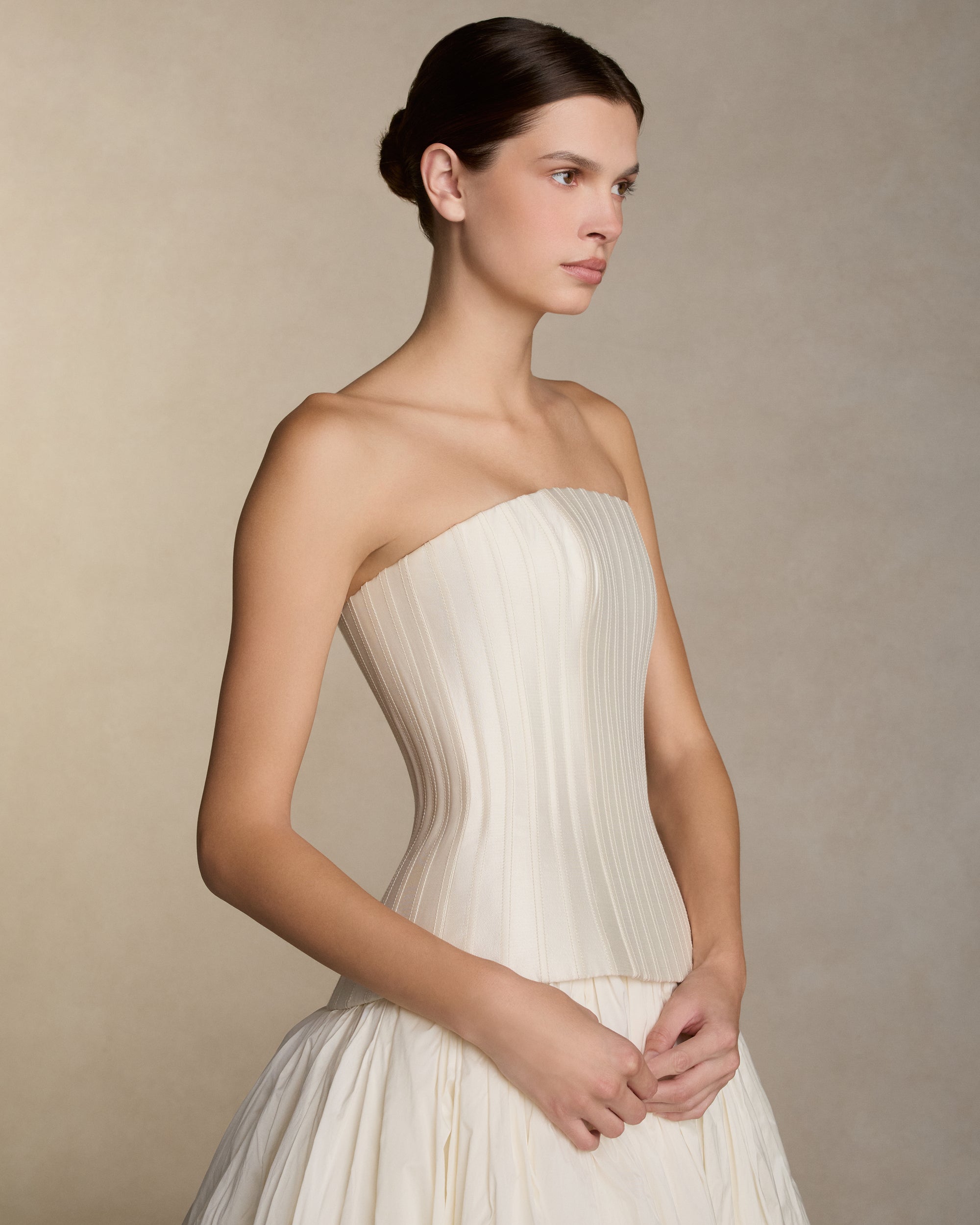 Dramatic tissue taffeta ball skirt with basque waist yoke and bubble hem. Invisible zip closure at center back.Styled with Veda Silk Wool Twill bustier