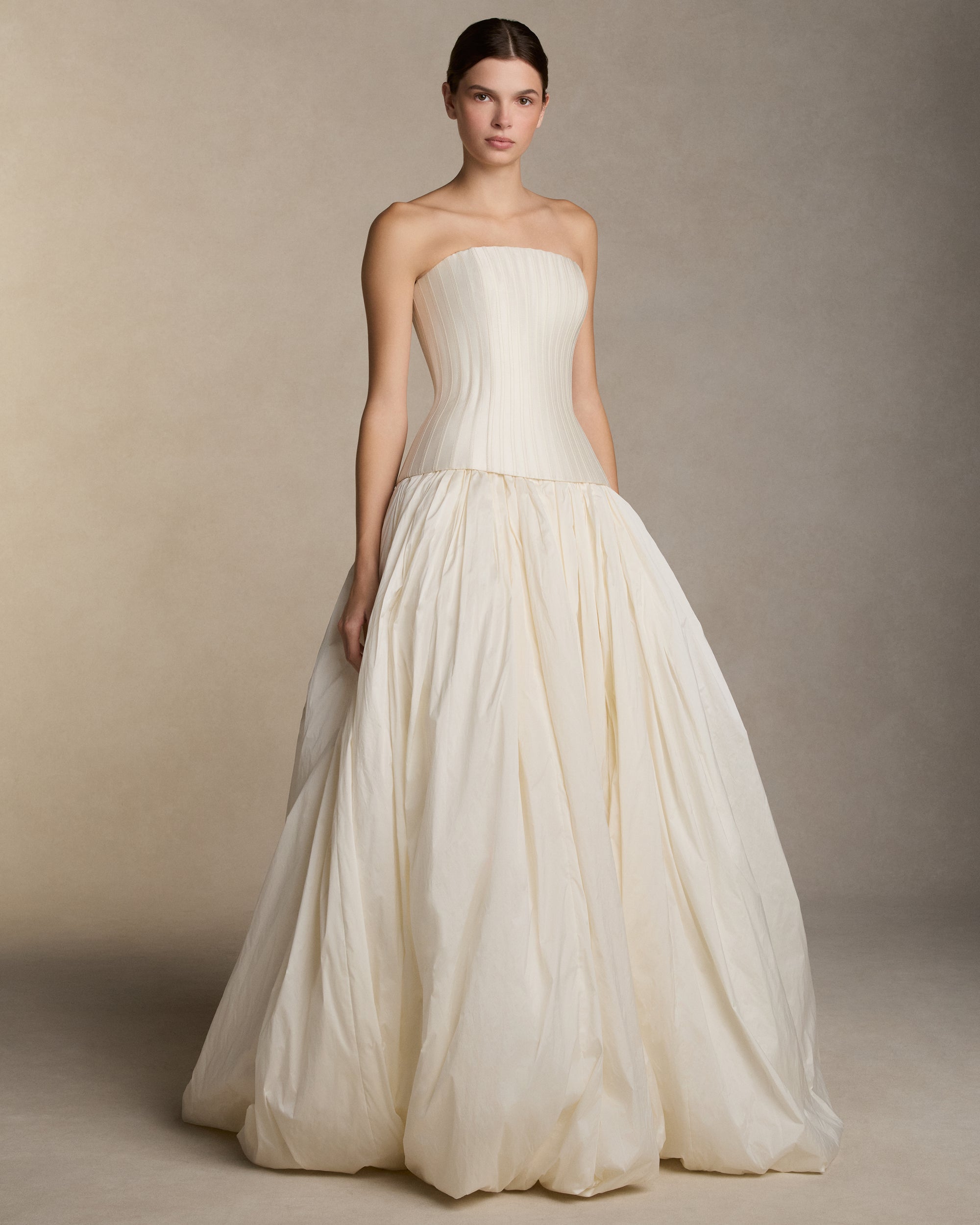 Dramatic tissue taffeta ball skirt with basque waist yoke and bubble hem. Invisible zip closure at center back.Styled with Veda Silk Wool Twill bustier