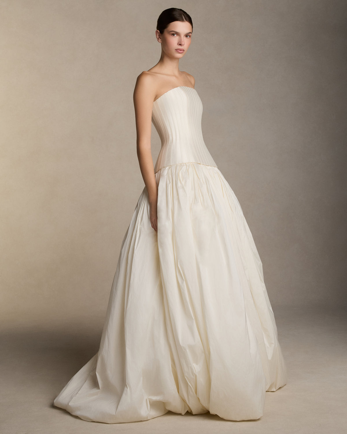 Dramatic tissue taffeta ball skirt with basque waist yoke and bubble hem. Invisible zip closure at center back.Styled with Veda Silk Wool Twill bustier