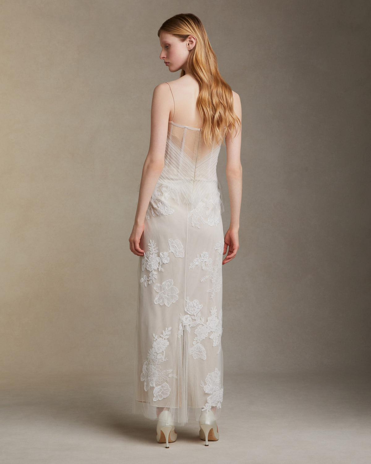 Camisole bustier top suspended by delicate spaghetti straps. Picot tulle ribbons criss cross across bodice, falling organically over hem. Boned corset revealed at center back. Center back zip closure.Styled with Theo SkirtStyled with Georgia Skirt
