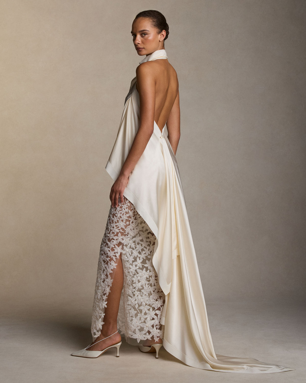 Sheer column skirt with star flower pearl embroidery. Thousands of hand cut silk chiffon petals with baroque pearl centers veil a layer of sheer bobinette. Invisible zip closure at wearer’s left. Styled with Maude top