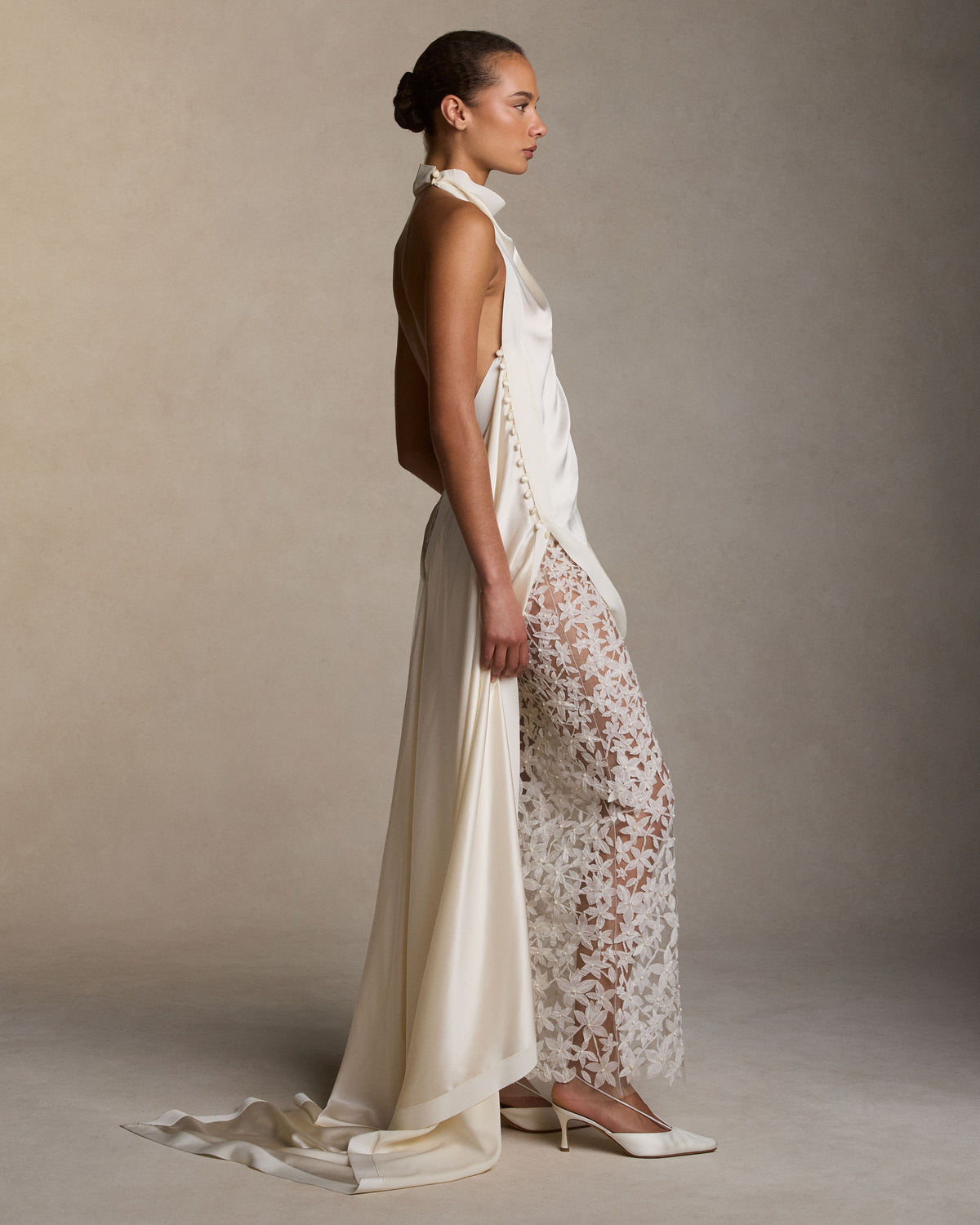 Sheer column skirt with star flower pearl embroidery. Thousands of hand cut silk chiffon petals with baroque pearl centers veil a layer of sheer bobinette. Invisible zip closure at wearer’s left. Styled with Maude top