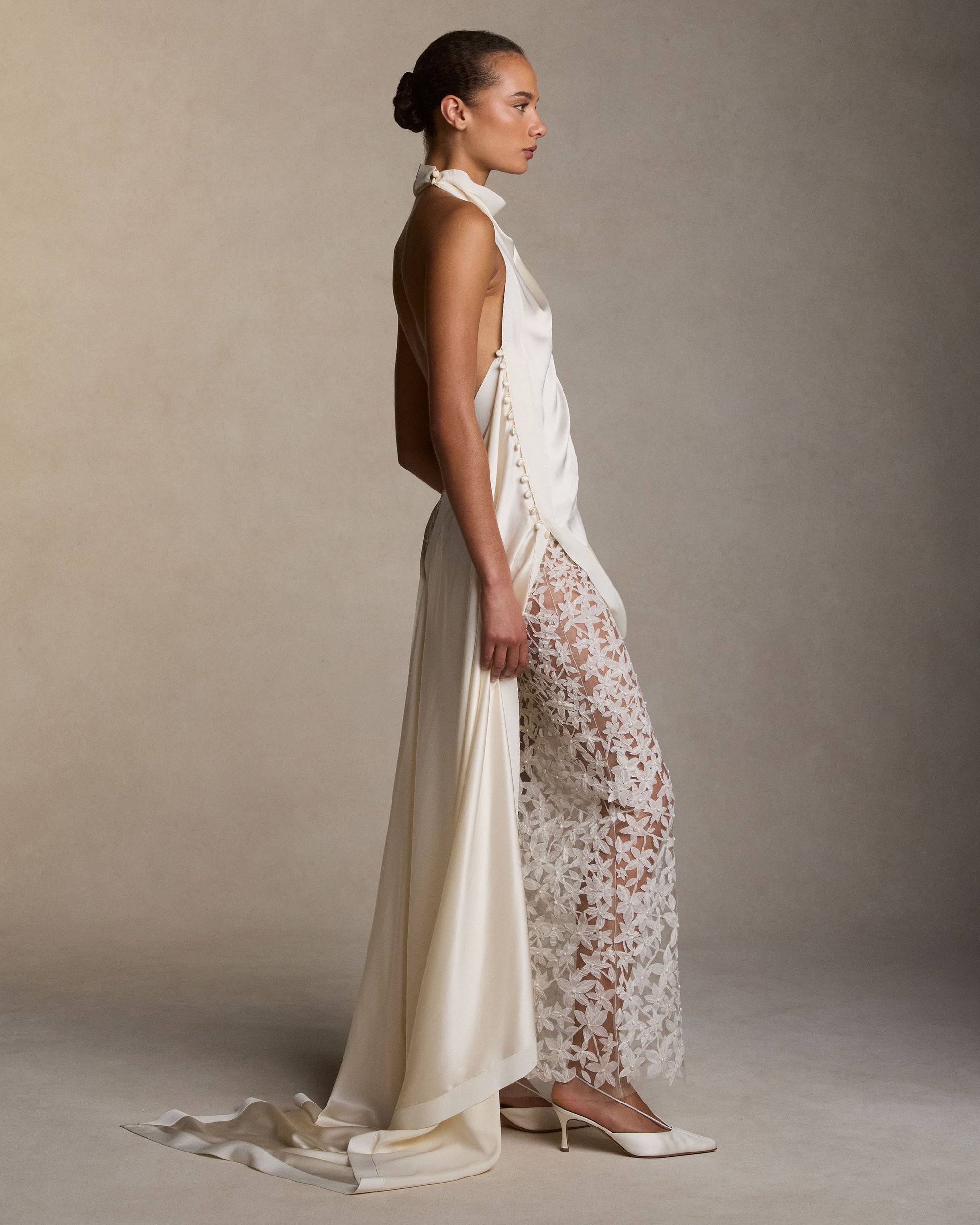 Sheer column skirt with star flower pearl embroidery. Thousands of hand cut silk chiffon petals with baroque pearl centers veil a layer of sheer bobinette. Invisible zip closure at wearer’s left. Styled with Maude top