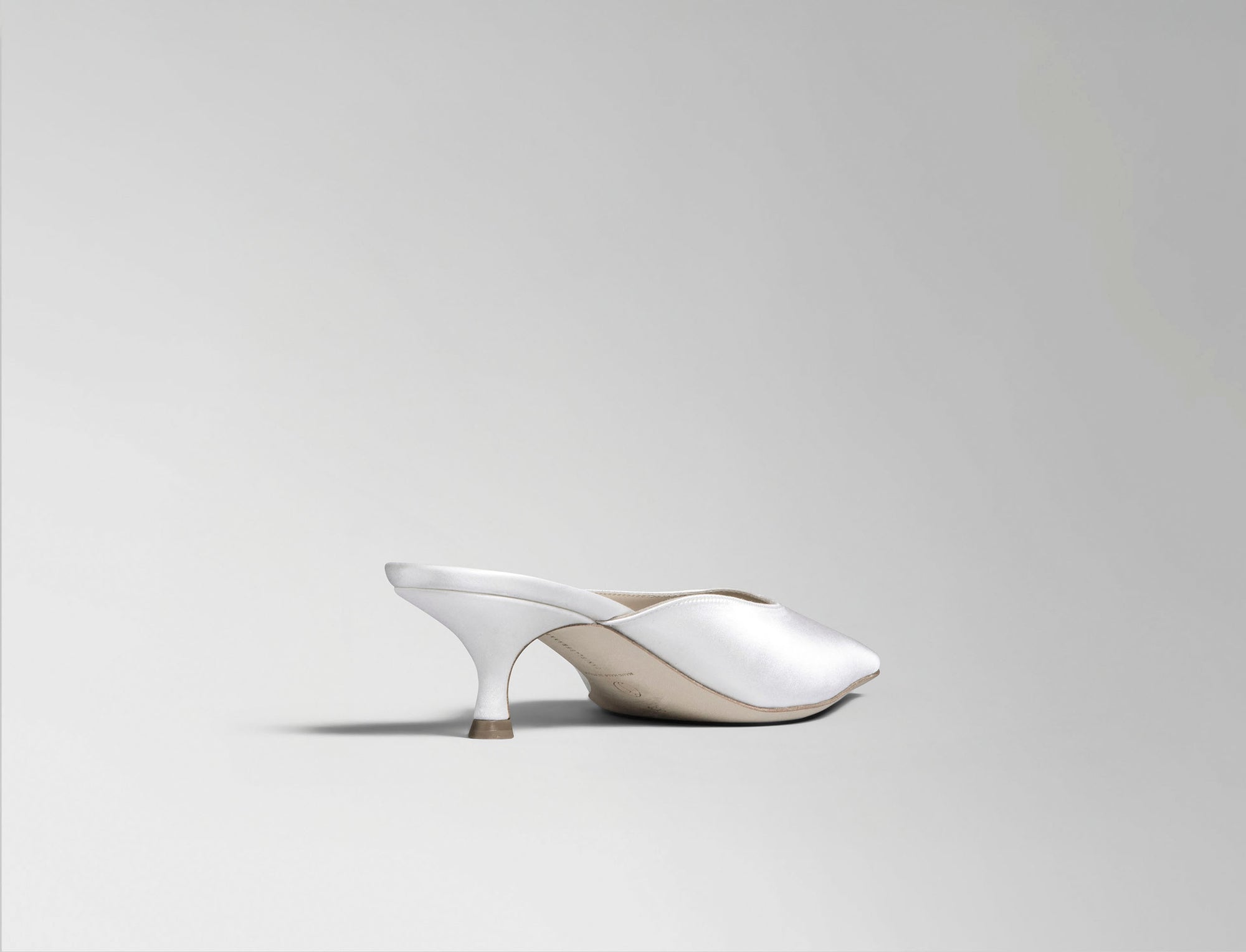 Ivory satin square toe mule with 50 mm kitten heel. Hand crafted in Italy.
