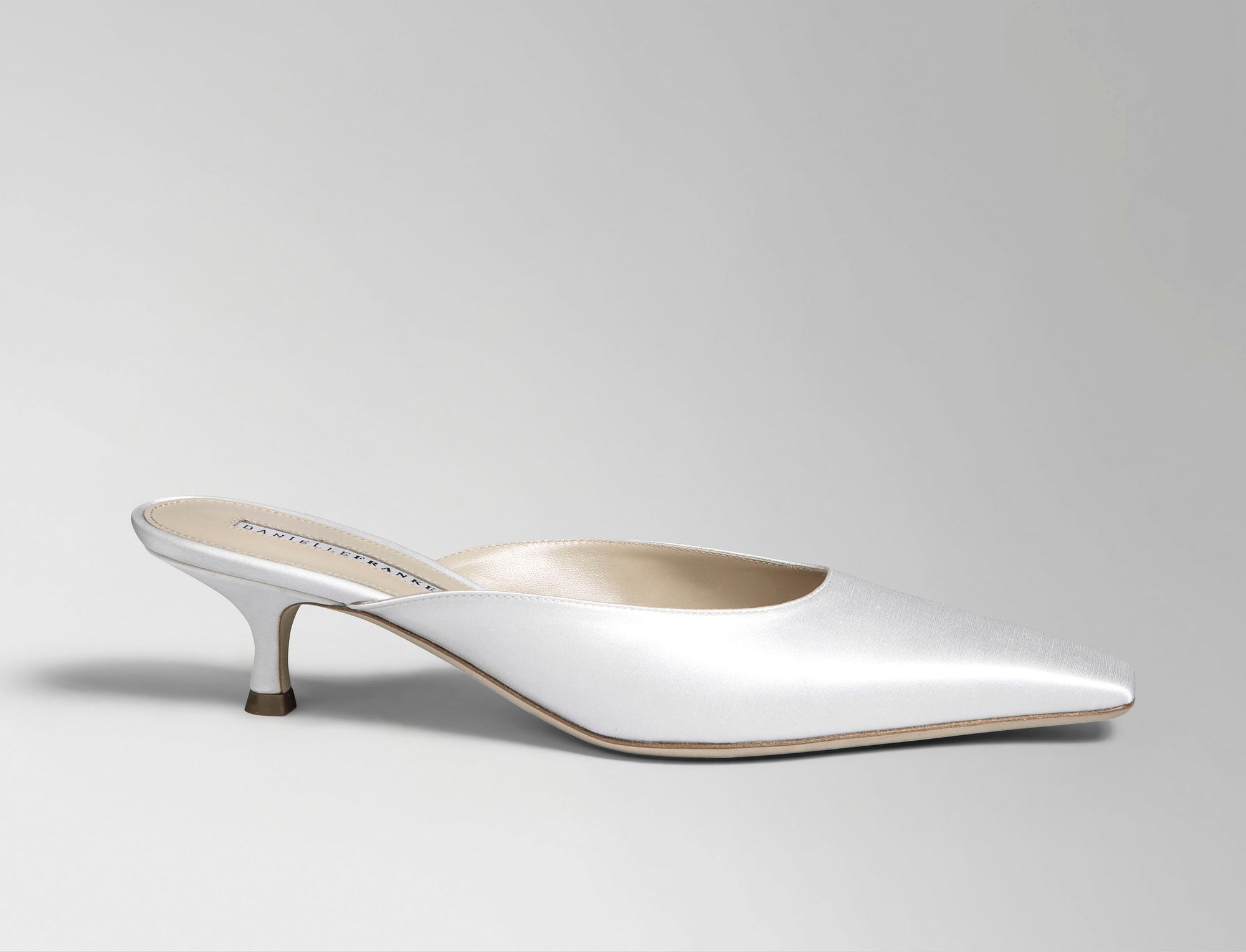 Ivory satin square toe mule with 50 mm kitten heel. Hand crafted in Italy.