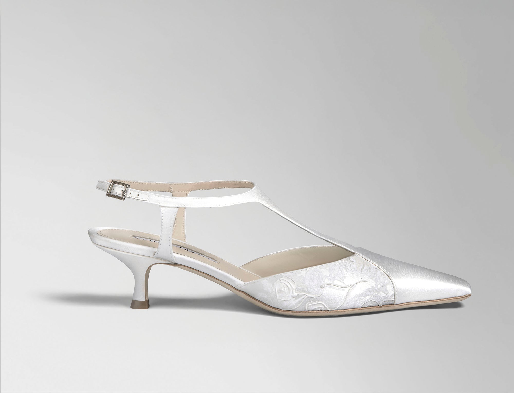 Ivory satin T-strap pump with square toe and pigment printed and hand painted detail. 50 mm kitten heel. Hand crafted in Italy.
