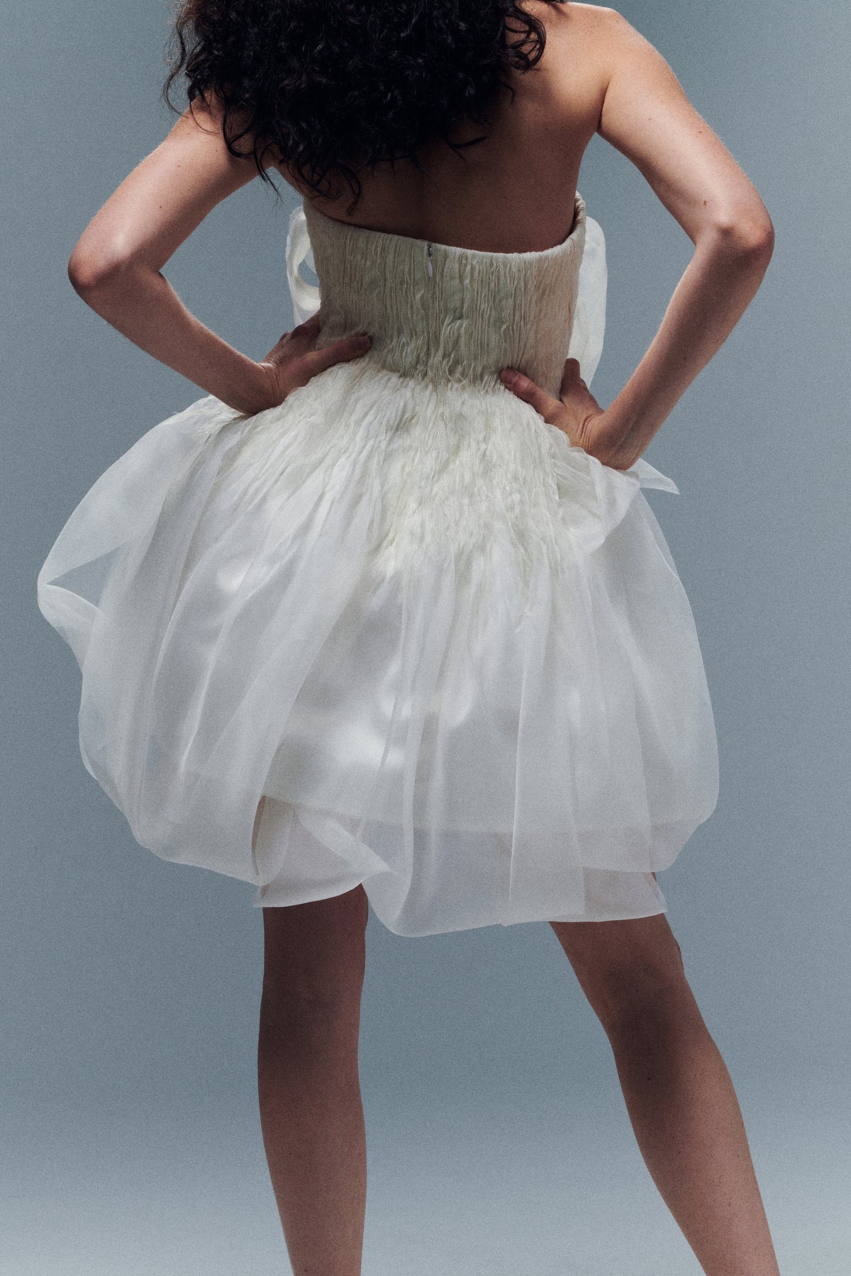 Organza petal mini dress. Dual layered with soft boning for structure, sheer organza bubbled skirt with ivory lining. Center back zip close.
