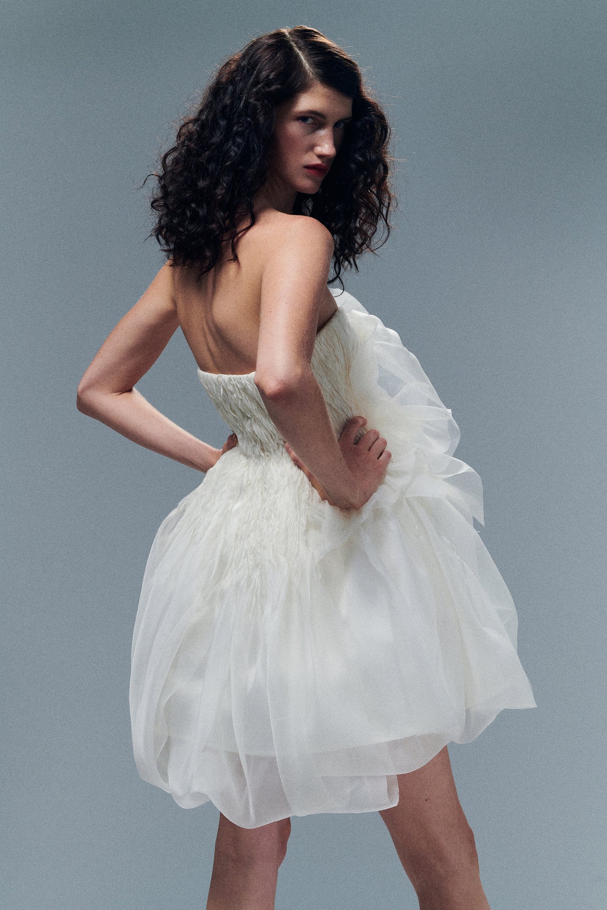 Organza petal mini dress. Dual layered with soft boning for structure, sheer organza bubbled skirt with ivory lining. Center back zip close.