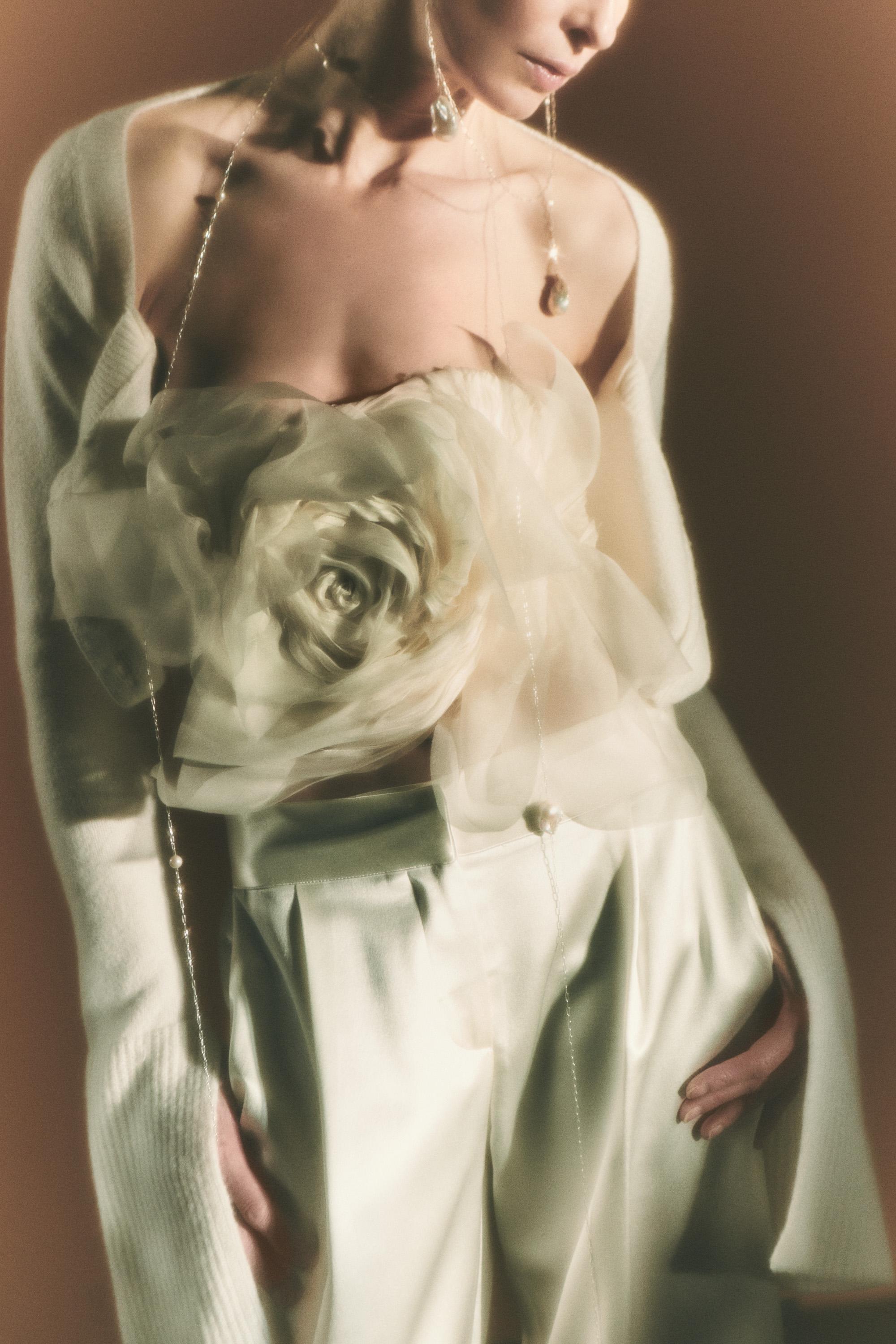 Organza petal strapless bustier. Dual layered with soft boning for structure, sheer organza petals and ivory lining. Center back zip close.Styled with Rory pant