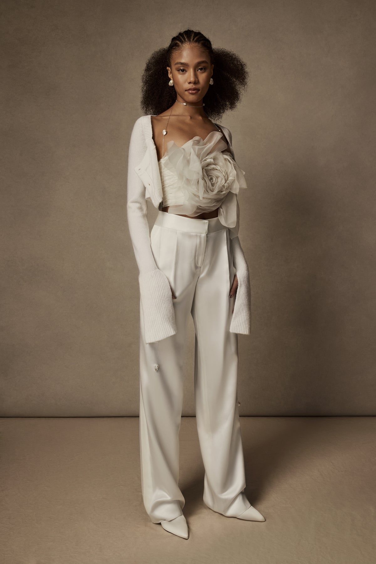 Sits at natural waist, tailored silk wool pant with grosgrain tuxedo detail. Menswear inspired pleated front with side pockets. Hook & eye zip with snap fastener and zip to close.