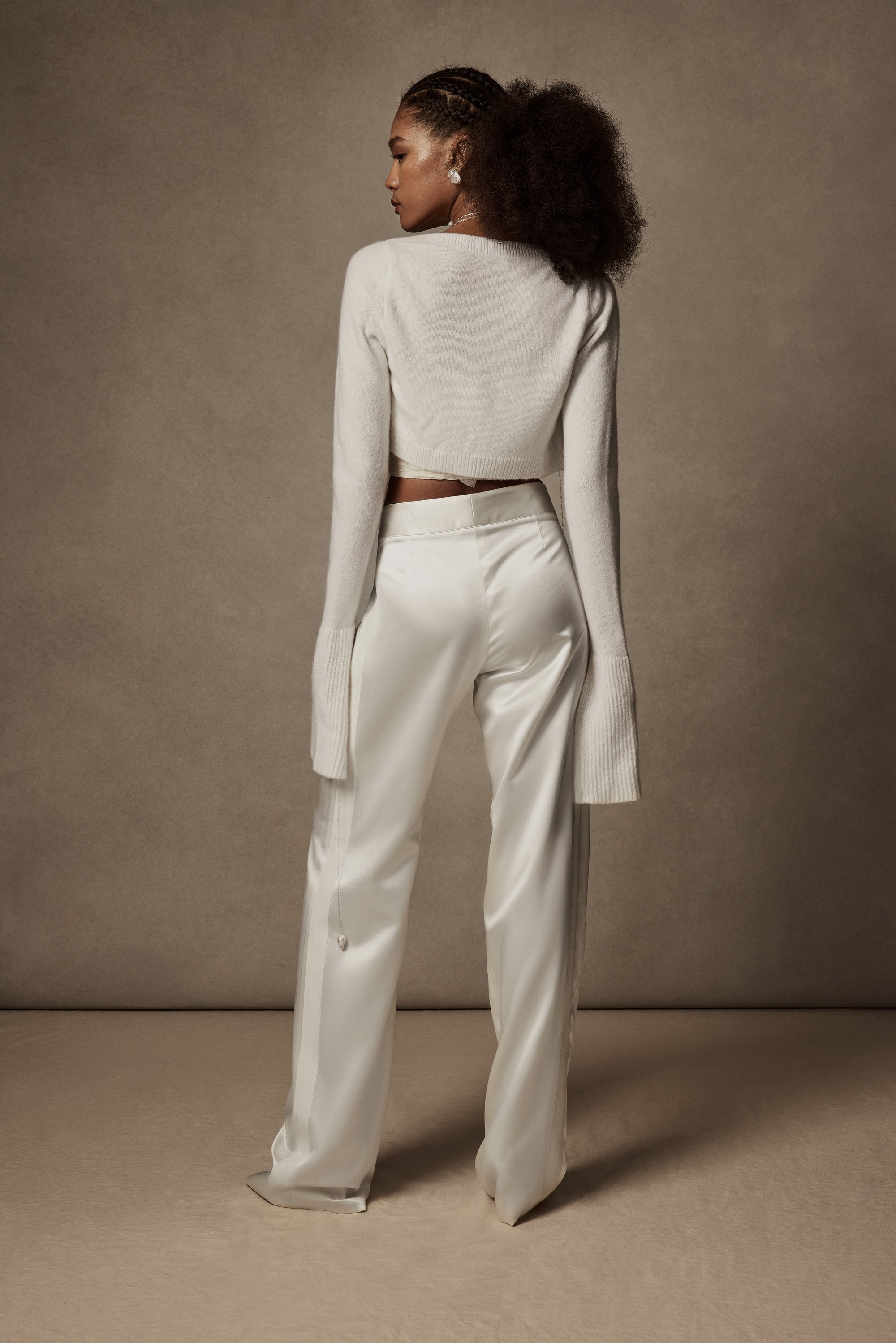 Sits at natural waist, tailored silk wool pant with grosgrain tuxedo detail. Menswear inspired pleated front with side pockets. Hook &amp; eye zip with snap fastener and zip to close.