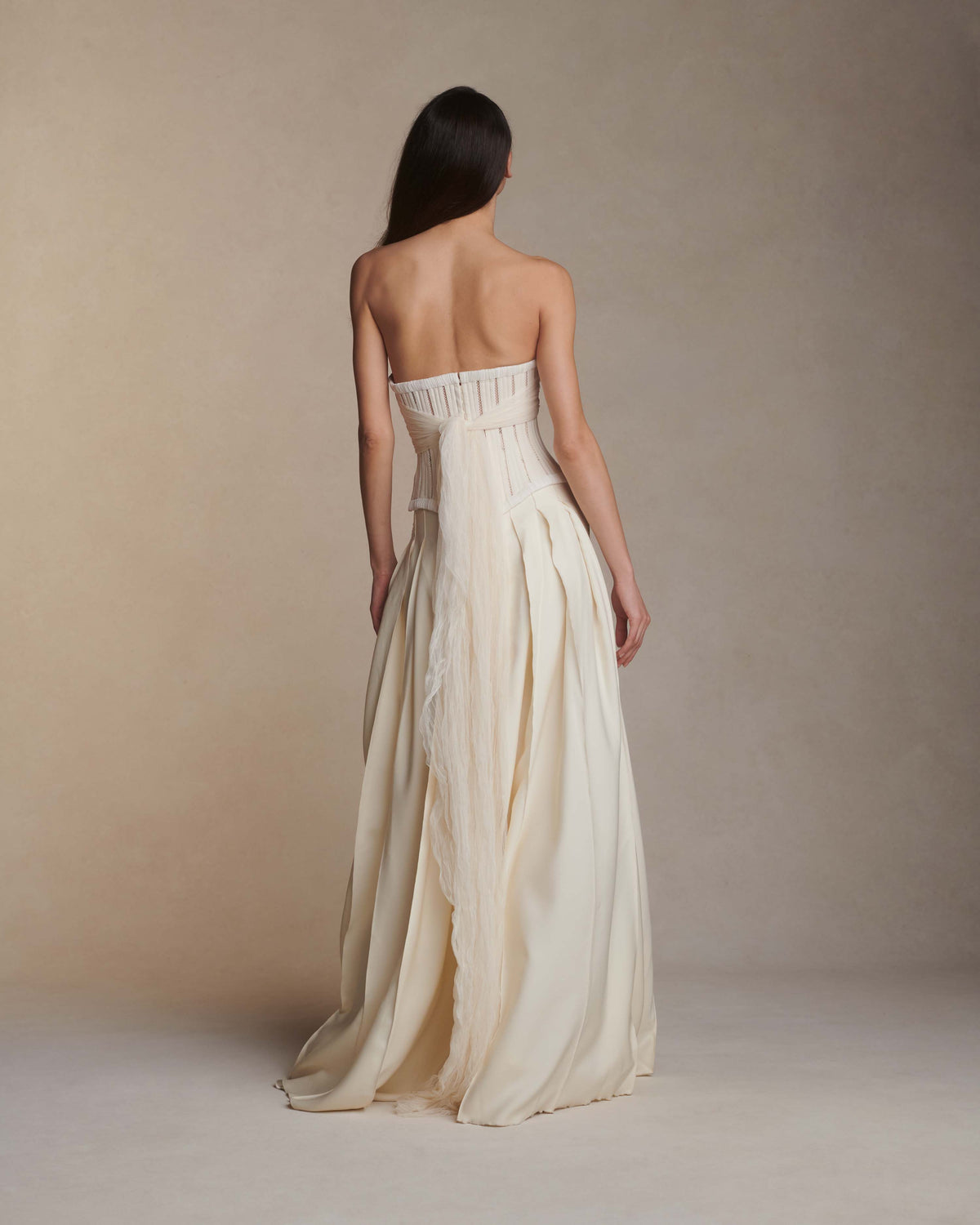 Lace and piped cotton twill basque waisted bodice. Exaggerated soft tulle, pleated streamers at bust and full hook and eye closure at back.Styled with Rory pant