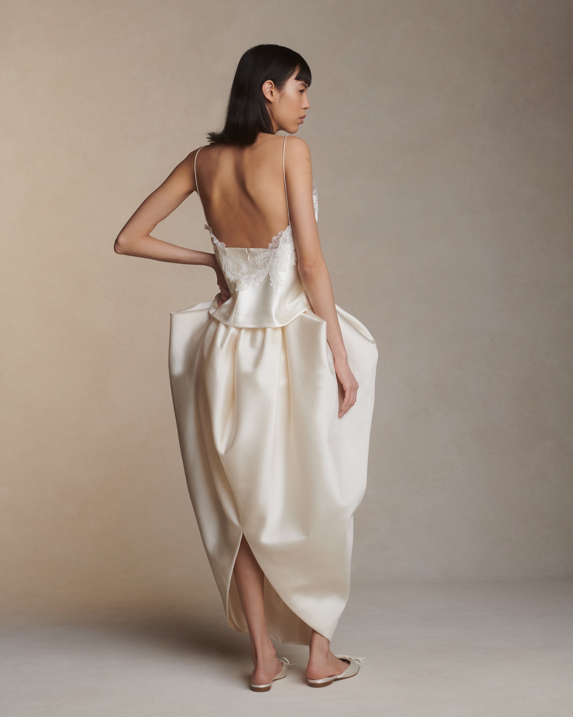 Bias cut silk wool camisole top with spaghetti straps and low back. Hand cut corded and chantilly lace adorn the hem. Slip on styling.Styled with Tilly skirt