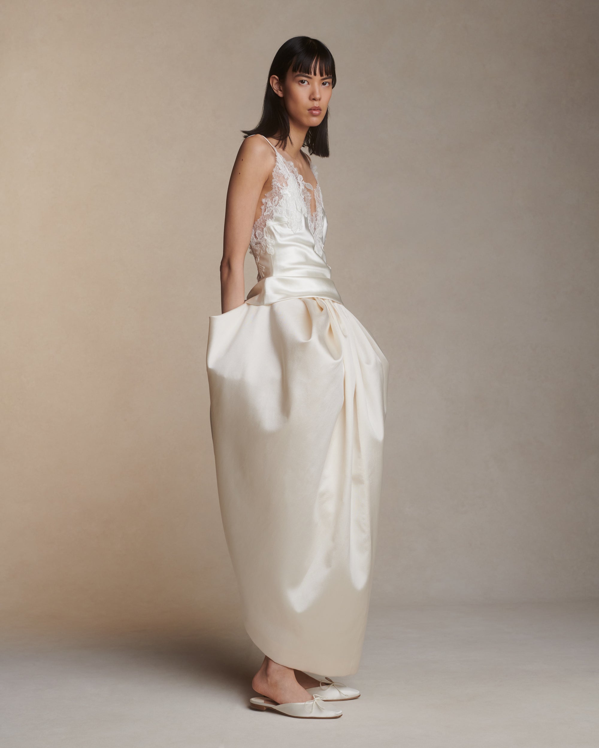 Bias cut silk wool camisole top with spaghetti straps and low back. Hand cut corded and chantilly lace adorn the hem. Slip on styling.Styled with Tilly skirt