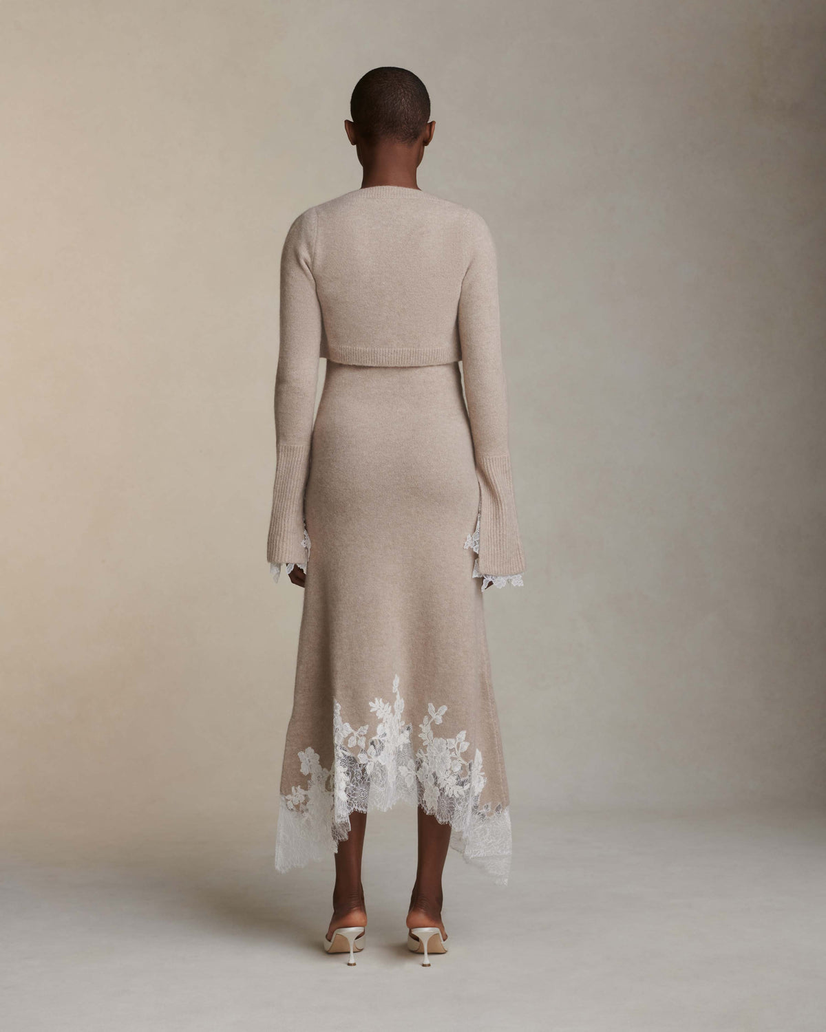 Silk cashmere cropped cardigan. Square neck, Chantilly handkerchief detail at cuff. Three button close.Fits true to size: 0/2 = XS2/4 = S6/8 = M8/10 = L10/12 = XL Styled with Cheryl dress
