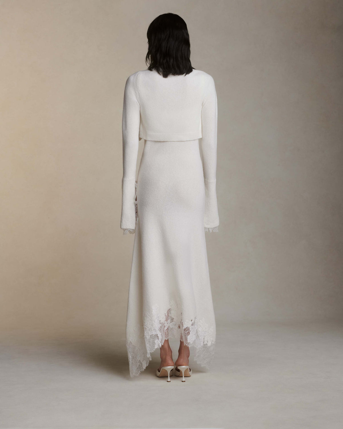 Silk cashmere cropped cardigan. Square neck, Chantilly handkerchief detail at cuff. Three button close.Fits true to size: 0/2 = XS2/4 = S6/8 = M8/10 = L10/12 = XL Styled with Cheryl dress