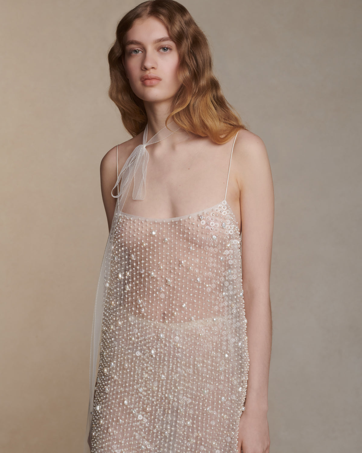 Air organza shift mini dress with soft square neckline suspended from delicate spaghetti straps. Hand embroidered with genuine baroque pearls and transparent sequins throughout. Center back zip closure. Unlined.   Styled with Lenny skirt