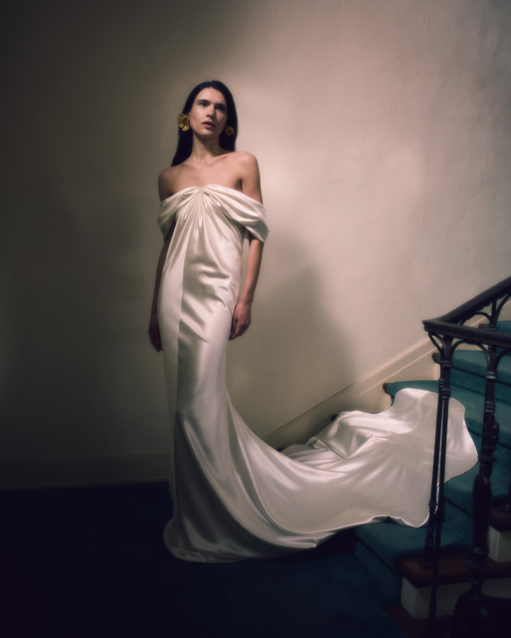 Off the shoulder silk wool gown with elegant draping at center front releasing into swagged sleeve detail. Boned internal bustier with soft cups, internal grosgrain waist belt and invisible side zip closure. 