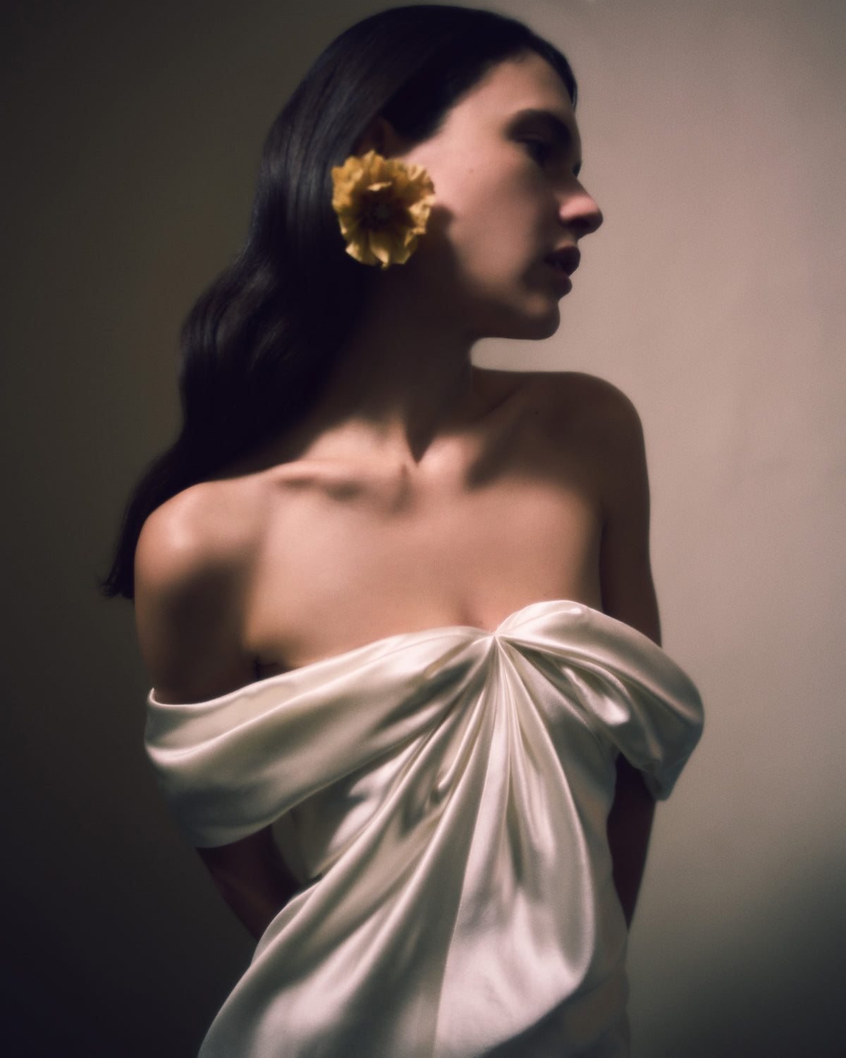 Off the shoulder silk wool gown with elegant draping at center front releasing into swagged sleeve detail. Boned internal bustier with soft cups, internal grosgrain waist belt and invisible side zip closure. 