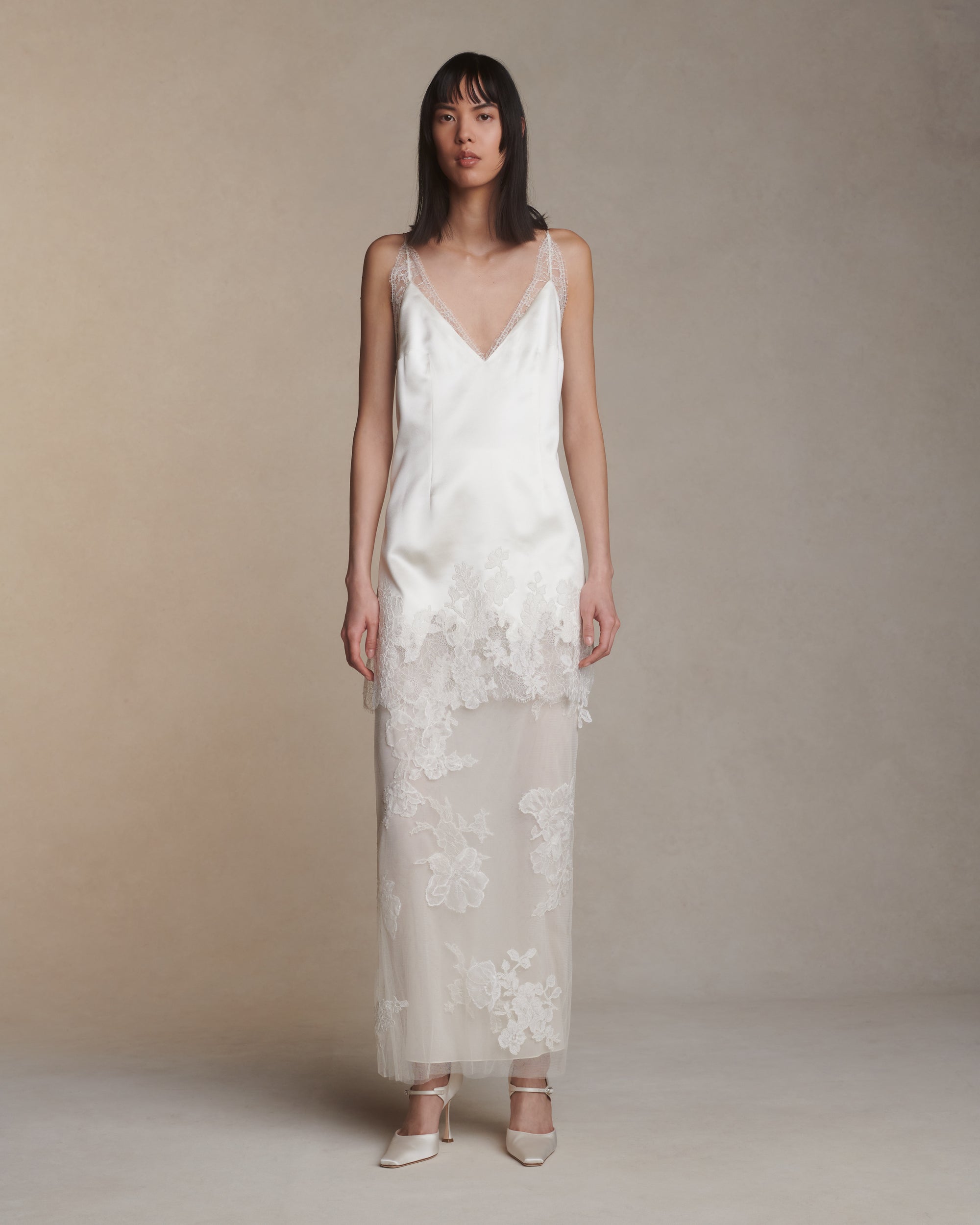 Silk column skirt with two layers of soft tulle adorned in hand cut corded and chantilly lace applique. Invisible side zip closure.Styled with Dan mini dress
