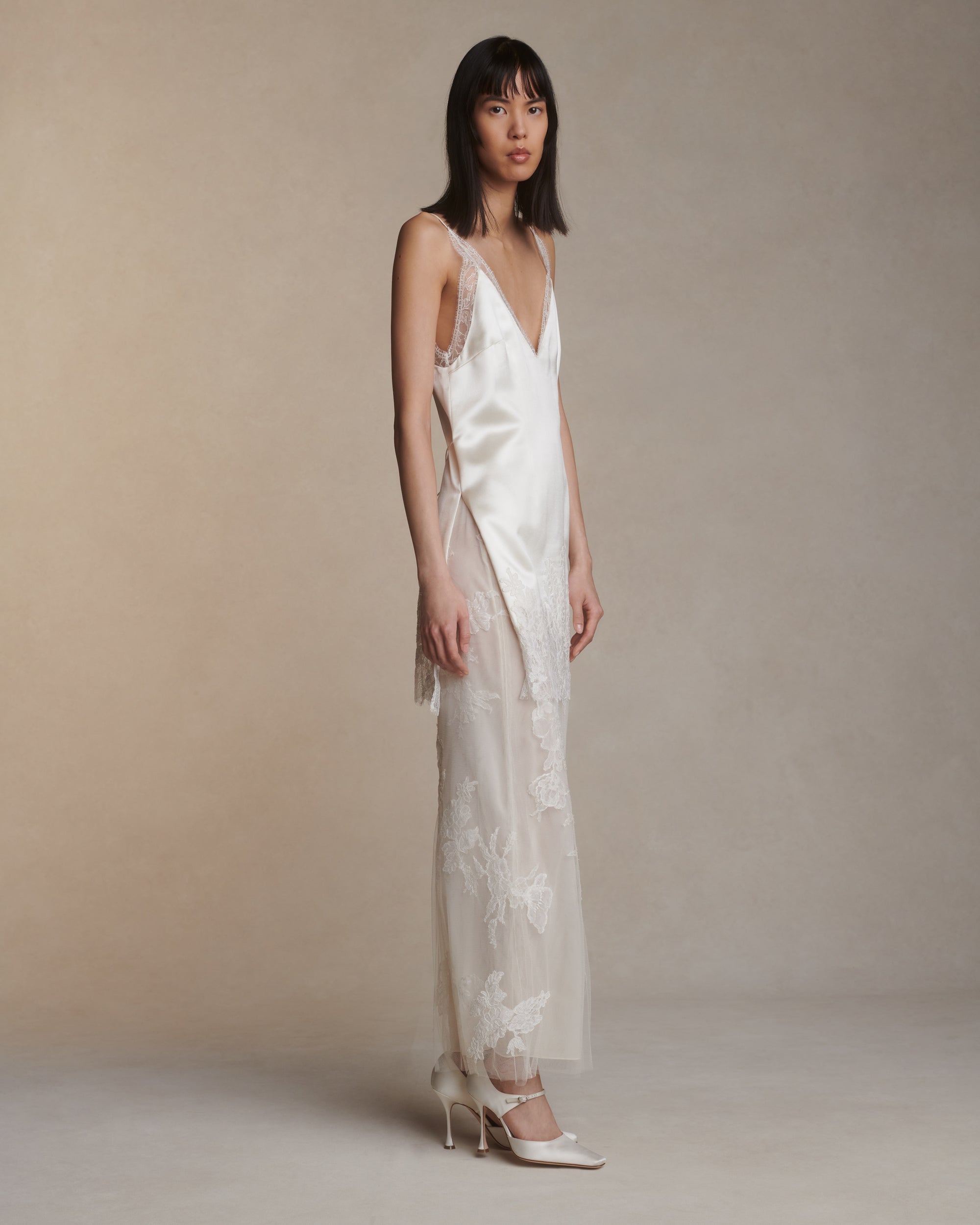 Silk column skirt with two layers of soft tulle adorned in hand cut corded and chantilly lace applique. Invisible side zip closure.Styled with Dan mini dress