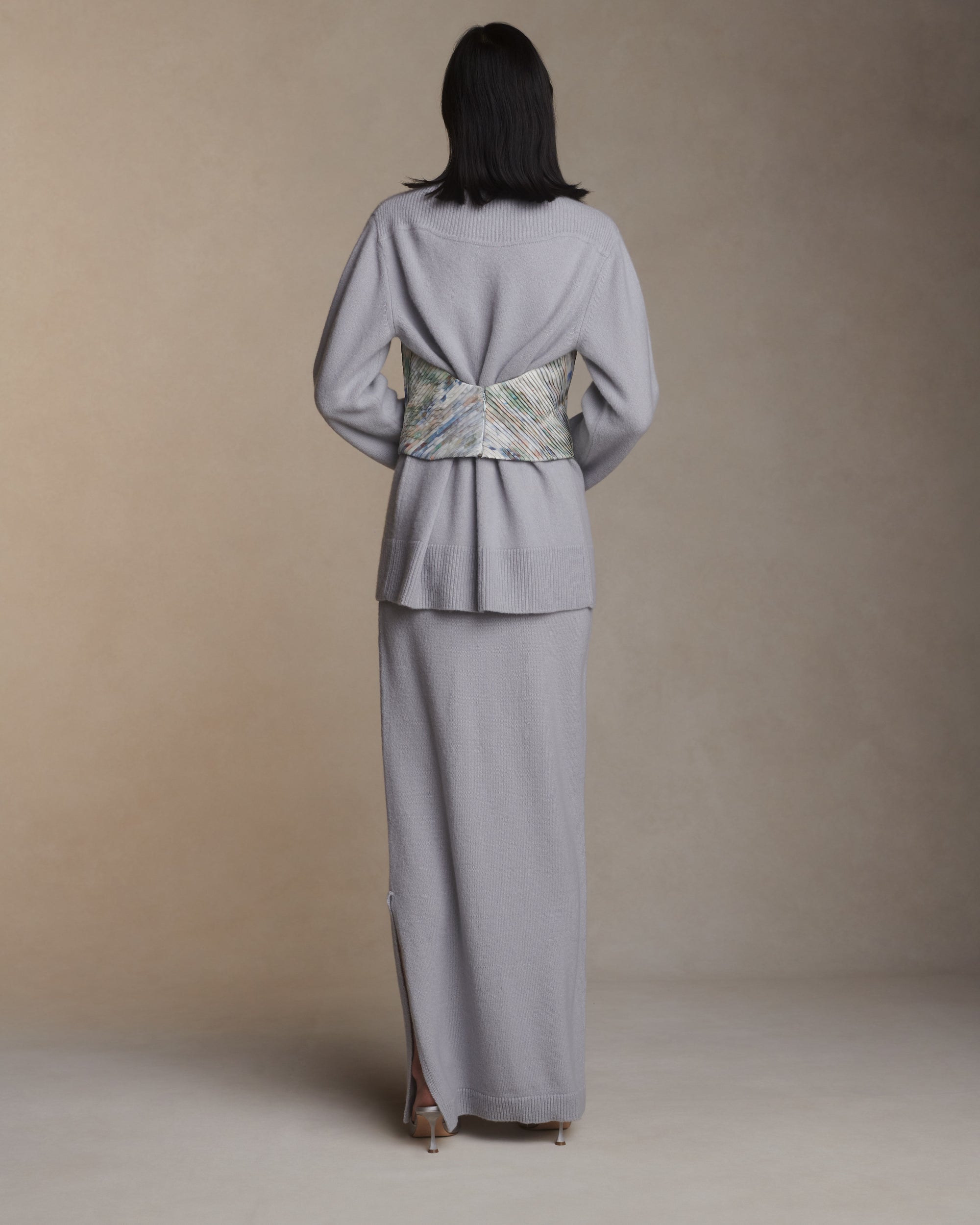 Strapless hand tucked silk taffeta bodice with piqued bust and scooped back. Angled micro tucking creates shape through waist. Boned internal bustier with soft cups, internal grosgrain waist belt and invisible side zip closure.