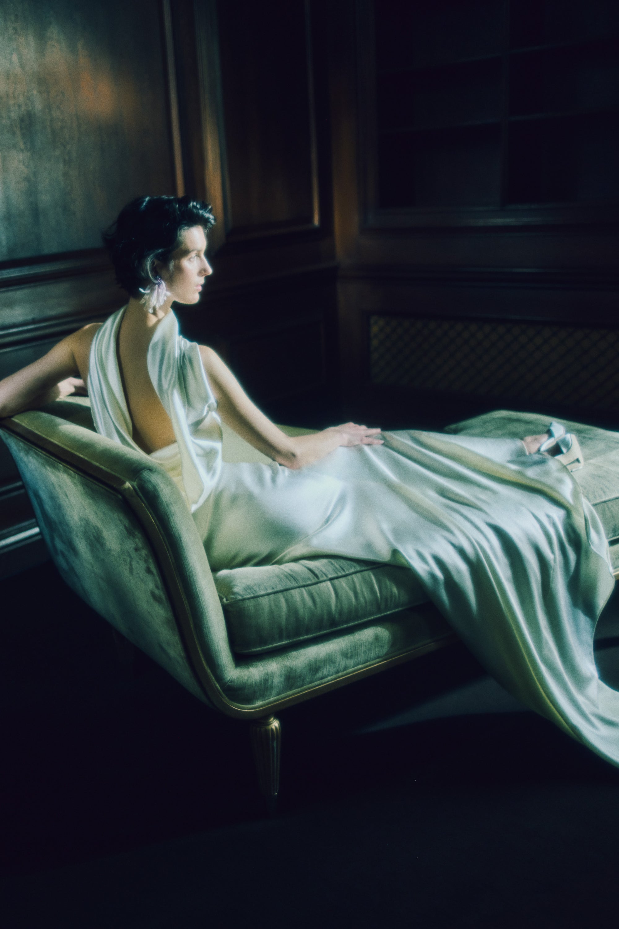 Strapless silk wool bias cut gown. Asymmetric drape wraps gracefully across neck and shoulders falling into a scarf drape detail at low back. Drape is removable with hidden covered buttons on bodice. Boned internal bustier with soft cups, internal grosgrain waist belt and invisible side zip closure.