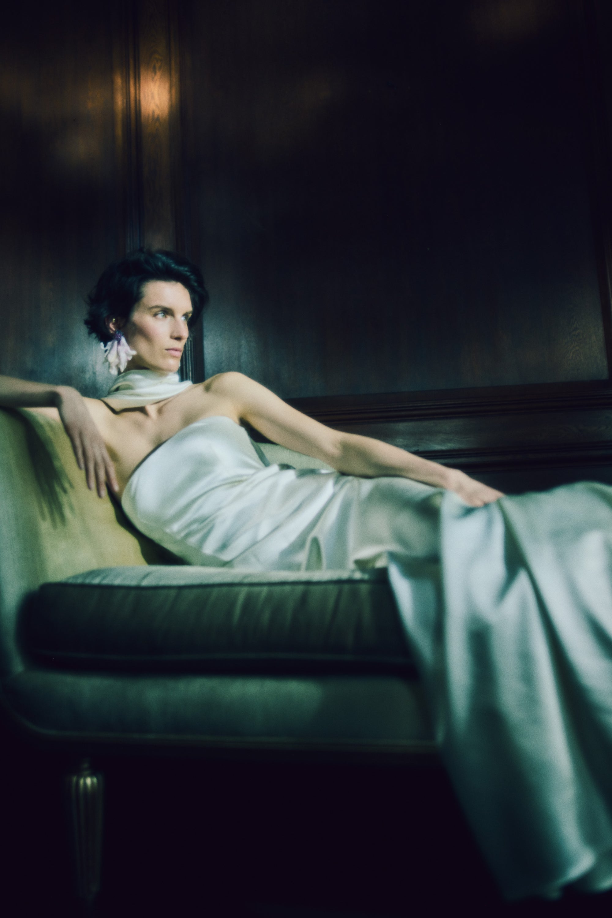 Strapless silk wool bias cut gown. Asymmetric drape wraps gracefully across neck and shoulders falling into a scarf drape detail at low back. Drape is removable with hidden covered buttons on bodice. Boned internal bustier with soft cups, internal grosgrain waist belt and invisible side zip closure.