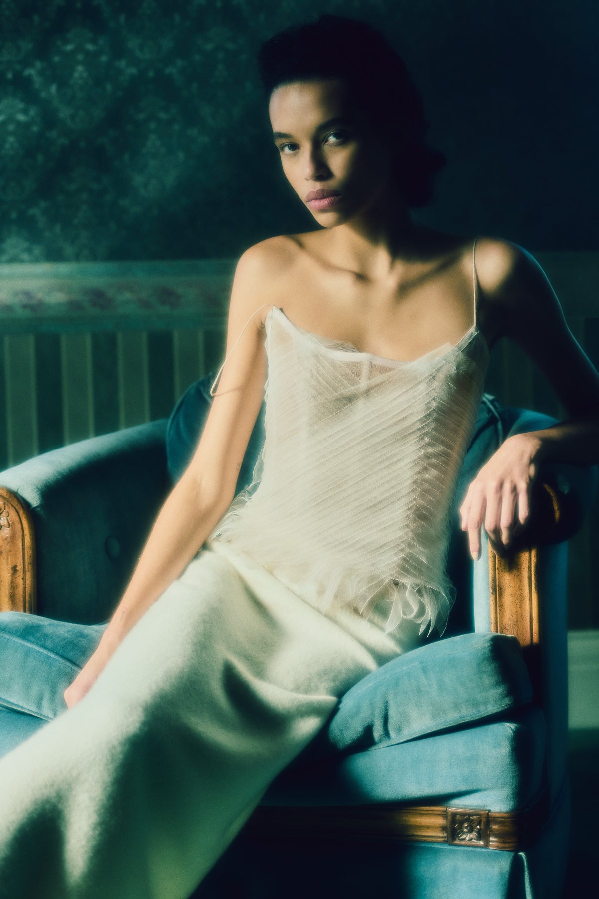 Camisole bustier top suspended by delicate spaghetti straps. Picot tulle ribbons criss cross across bodice, falling organically over hem. Boned corset revealed at center back. Center back zip closure.Styled with Theo SkirtStyled with Georgia Skirt