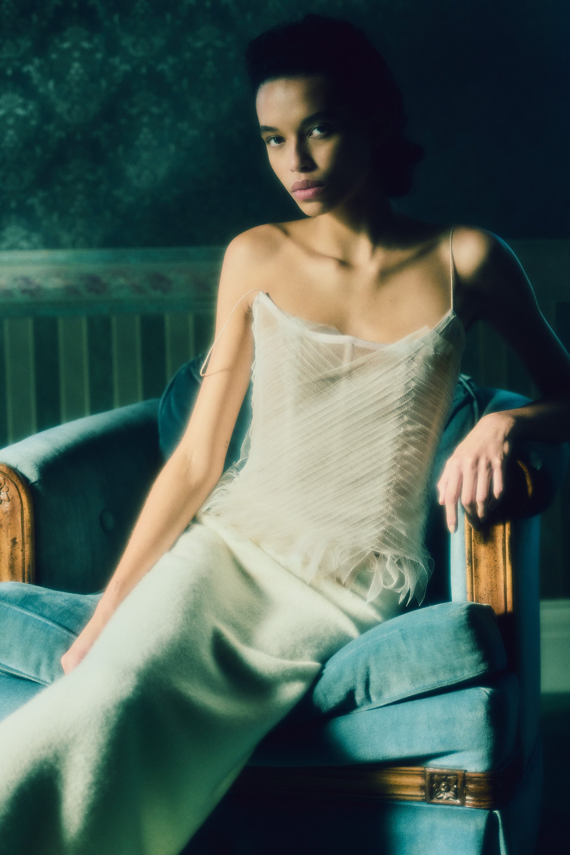 Camisole bustier top suspended by delicate spaghetti straps. Picot tulle ribbons criss cross across bodice, falling organically over hem. Boned corset revealed at center back. Center back zip closure.Styled with Theo SkirtStyled with Georgia Skirt