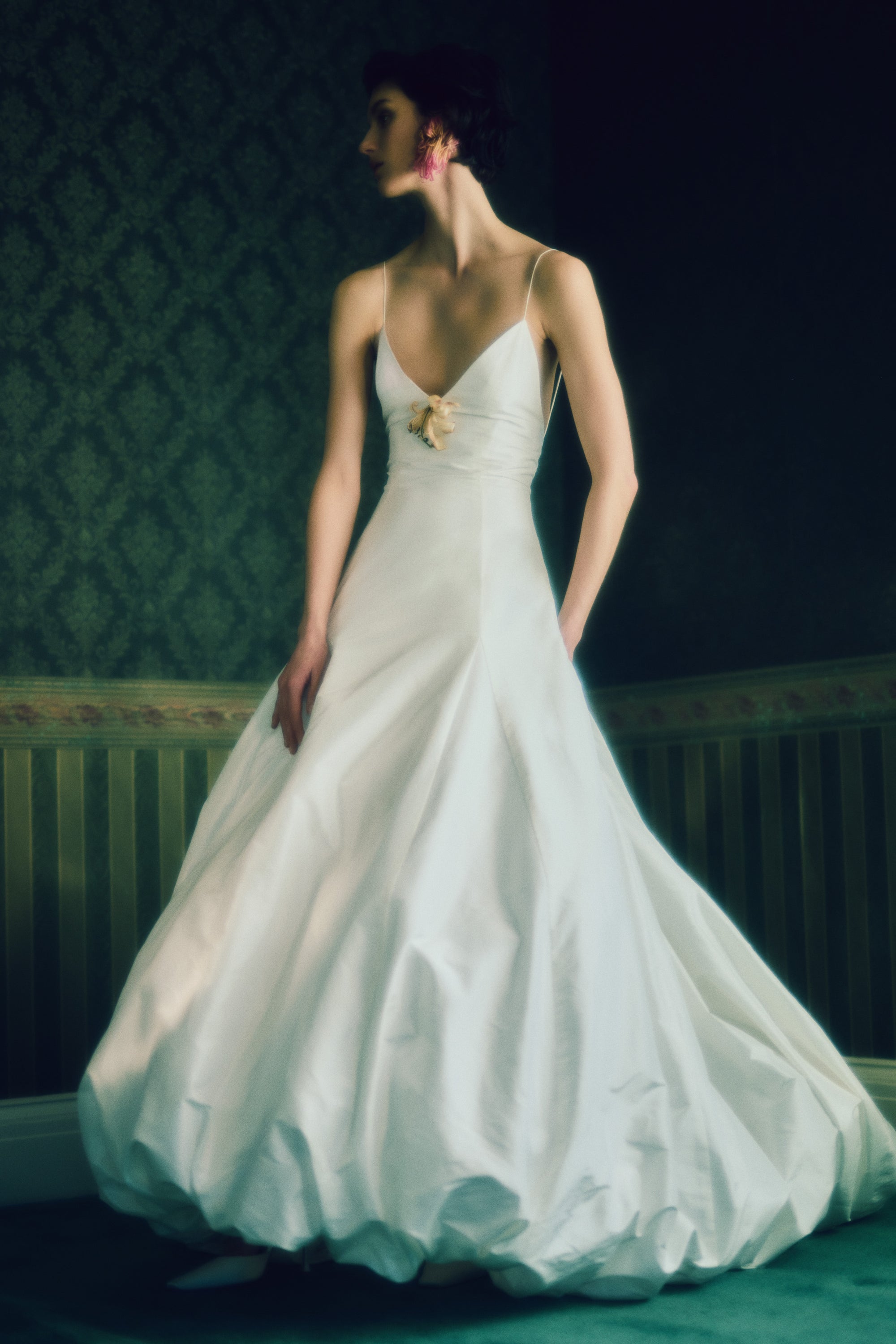 Crisp silk taffeta gown with dramatic bubbled skirt and train. Delicate spaghetti straps, deep V-neck and low V-back. Invisible zip closure at center back.