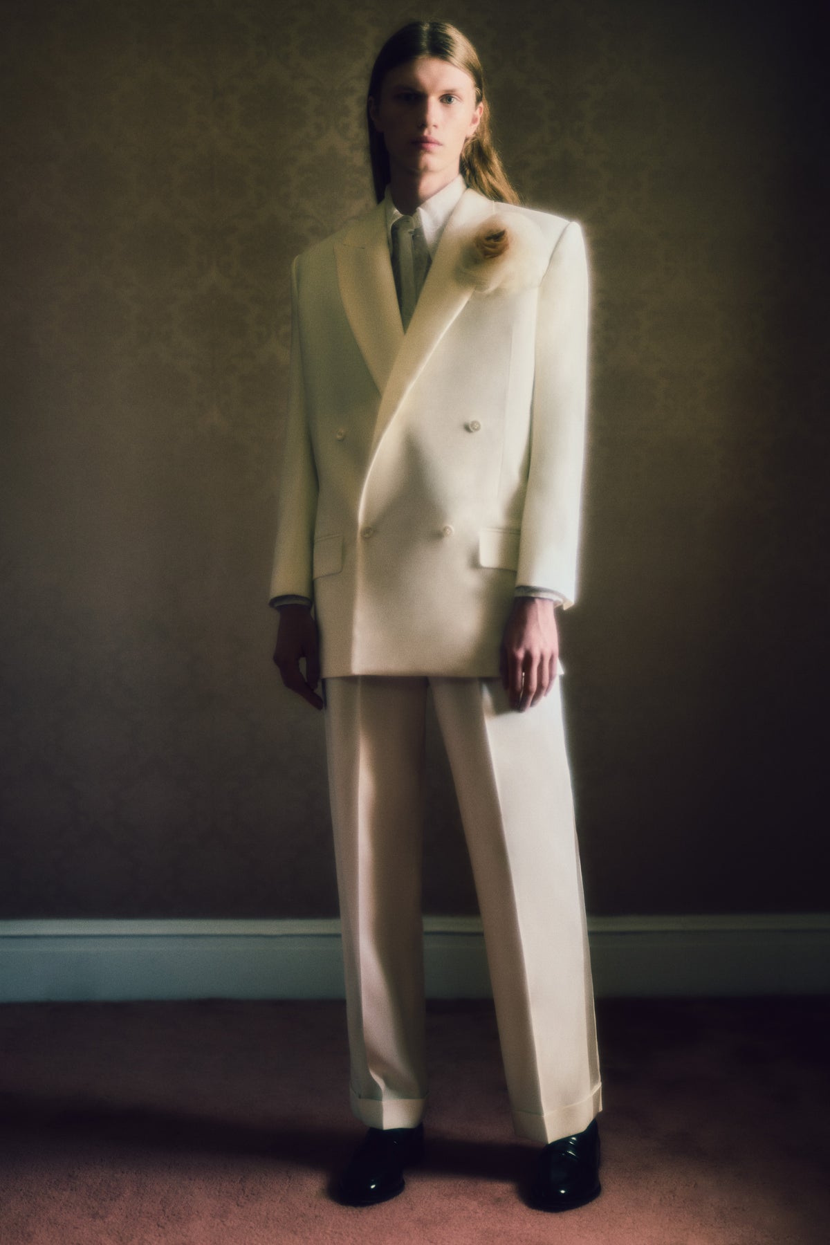 Matte silk wool double breasted jacket with luminous silk wool peaked lapel. Two welt pockets at front and double vented back. Ivory shell buttons at center front and sleeve opening.