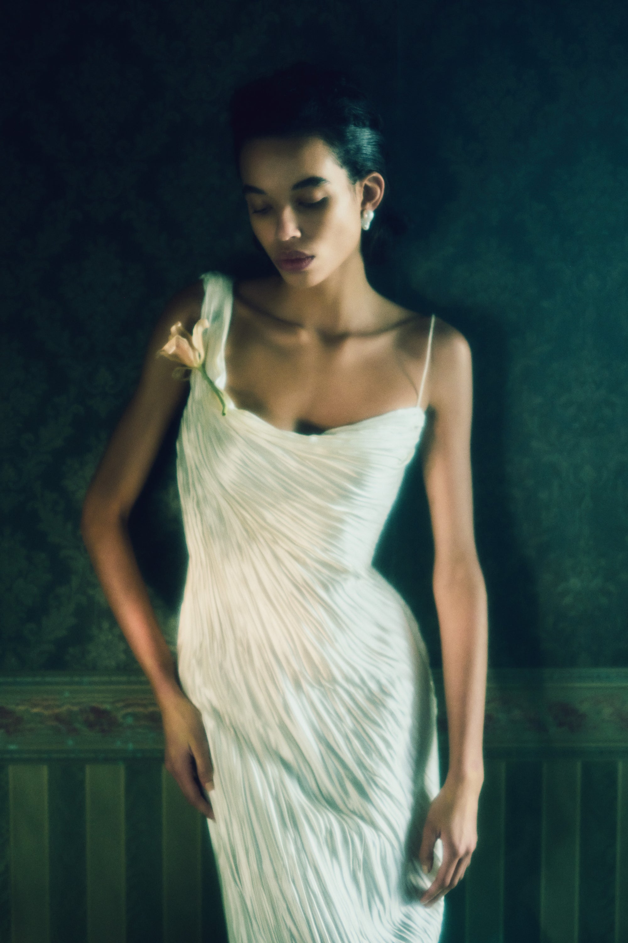 One shoulder pleated and hand crinkled silk wool cocktail length dress with dipped neckline. Asymmetric drape sweeps across front into a delicate twisted back detail. Boned internal bustier with soft cups, internal grosgrain waist belt and side zip closure.