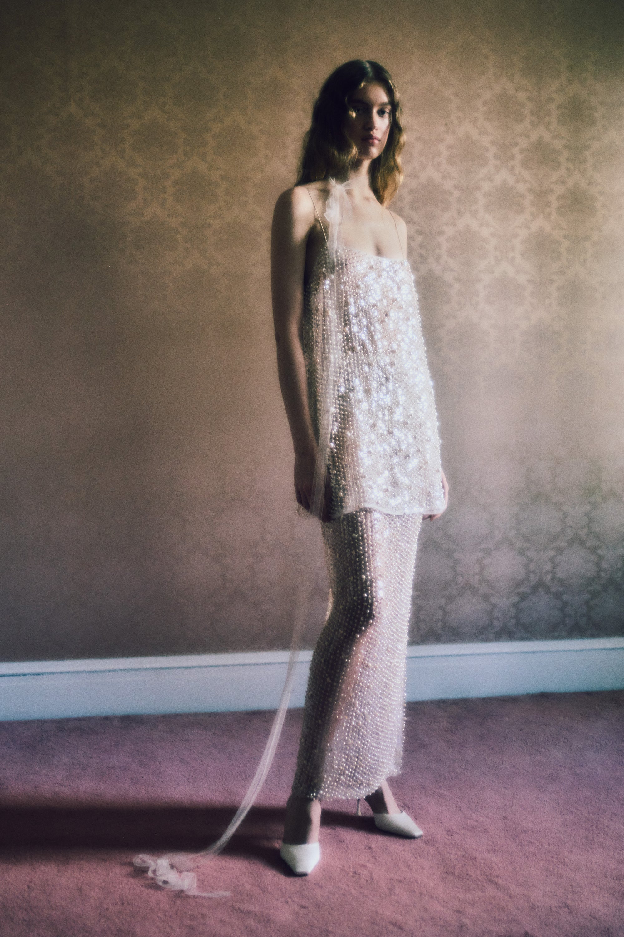 Air organza shift mini dress with soft square neckline suspended from delicate spaghetti straps. Hand embroidered with genuine baroque pearls and transparent sequins throughout. Center back zip closure. Unlined.   Styled with Lenny skirt