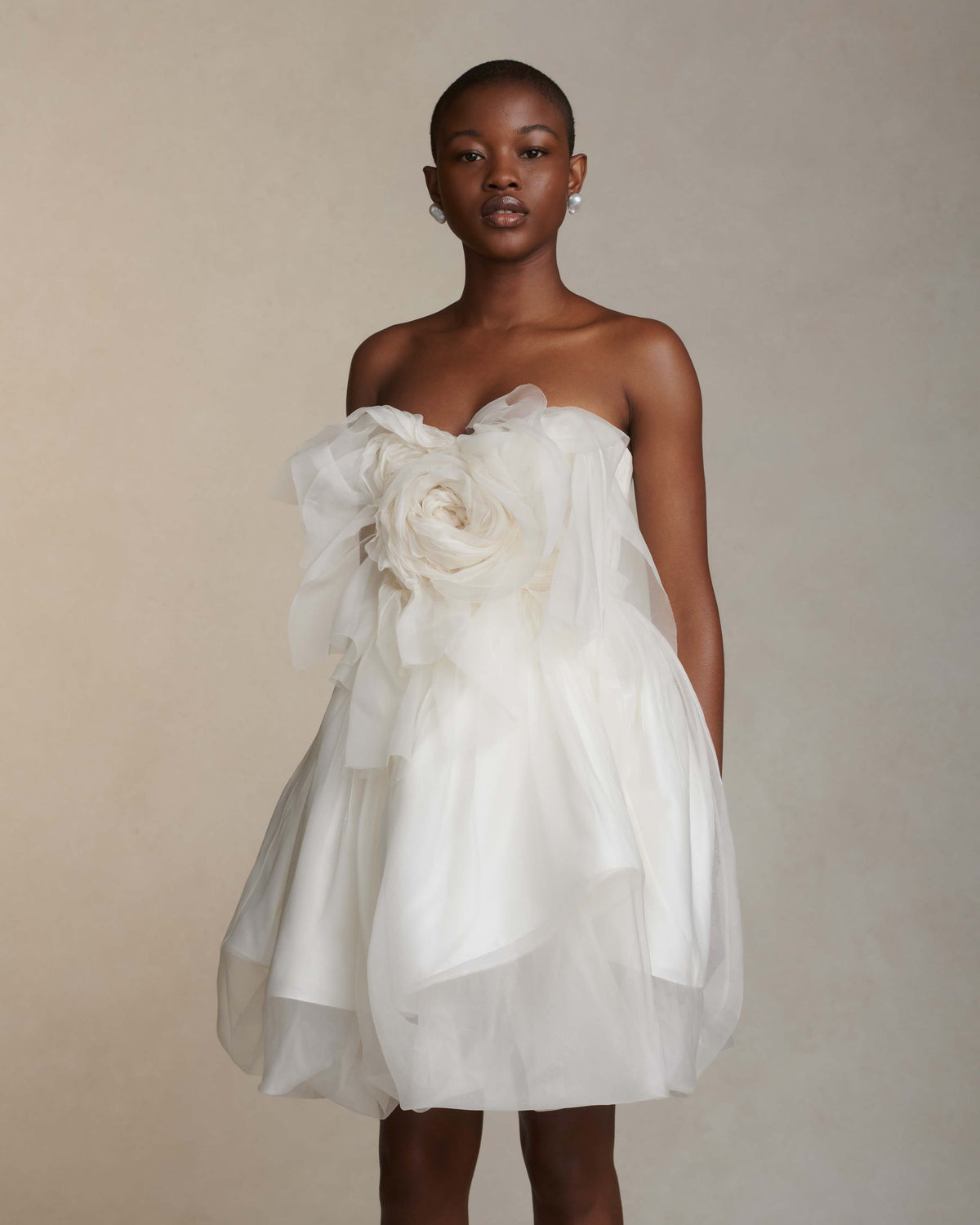 Organza petal mini dress. Dual layered with soft boning for structure, sheer organza bubbled skirt with ivory lining. Center back zip close.