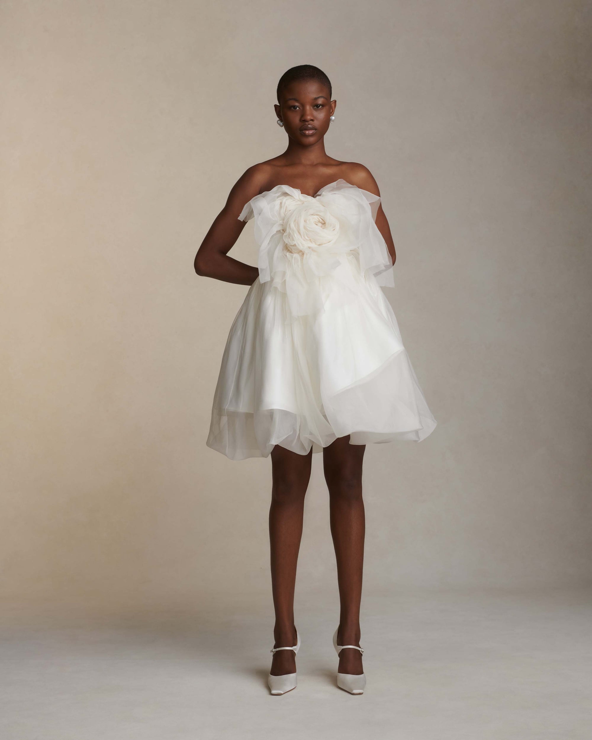 Organza petal mini dress. Dual layered with soft boning for structure, sheer organza bubbled skirt with ivory lining. Center back zip close.