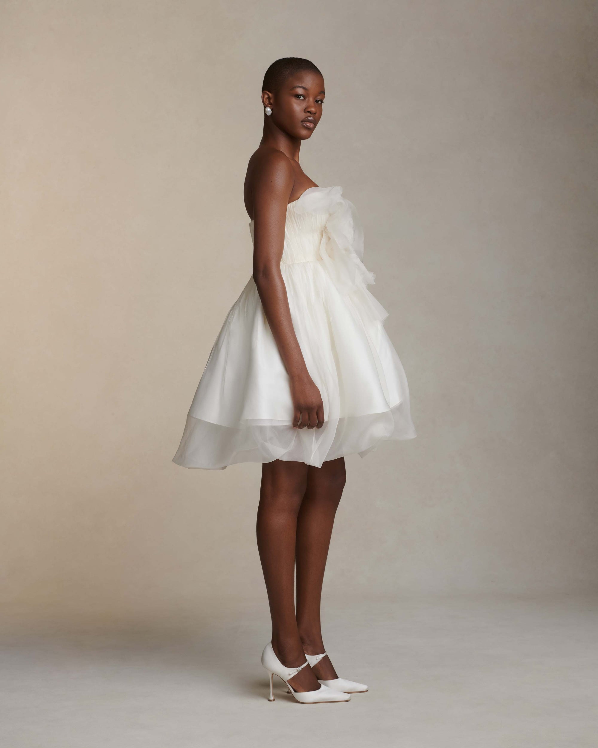 Organza petal mini dress. Dual layered with soft boning for structure, sheer organza bubbled skirt with ivory lining. Center back zip close.