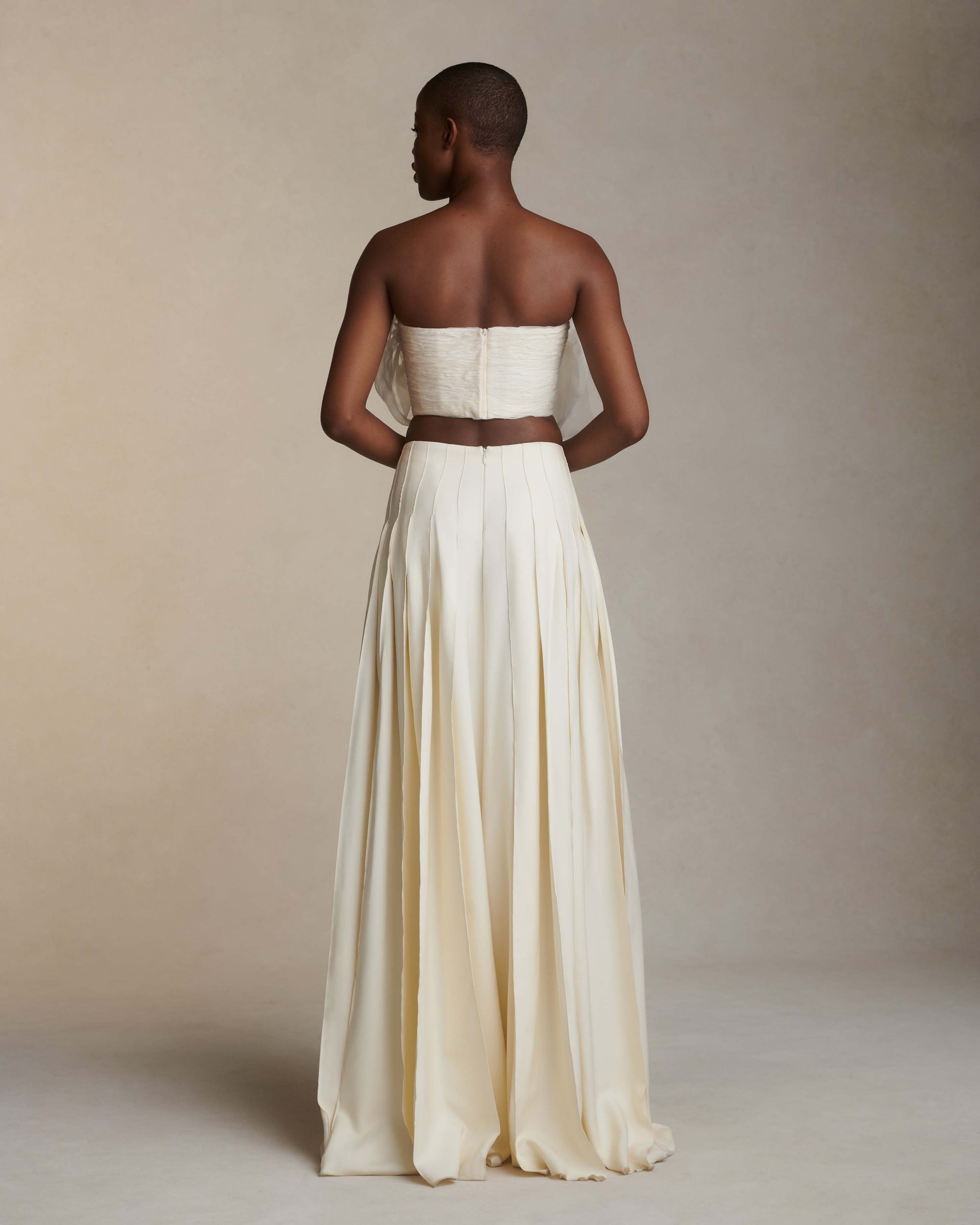 Silk wool palazzo pant with pin-tucked pleated detail. Side zip, hook and eye closure.Styled with Anika Bustier &amp; Macie top
