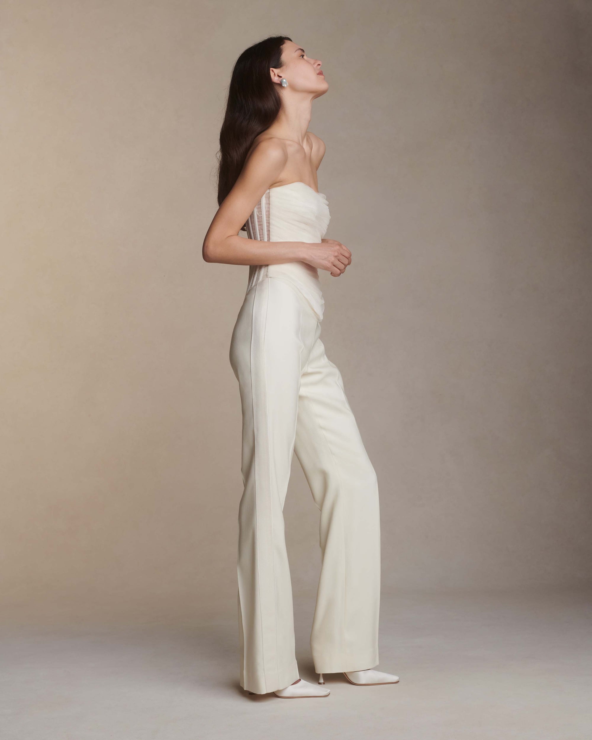 Structured corset top with dipped waist and layered soft tulle draping at front. Exposed organza bustier at back with grosgrain detail. Soft cups, internal grosgrain waist belt and invisible center back zip closure.Styled with Jack pant &amp; Jacqueline skirt 