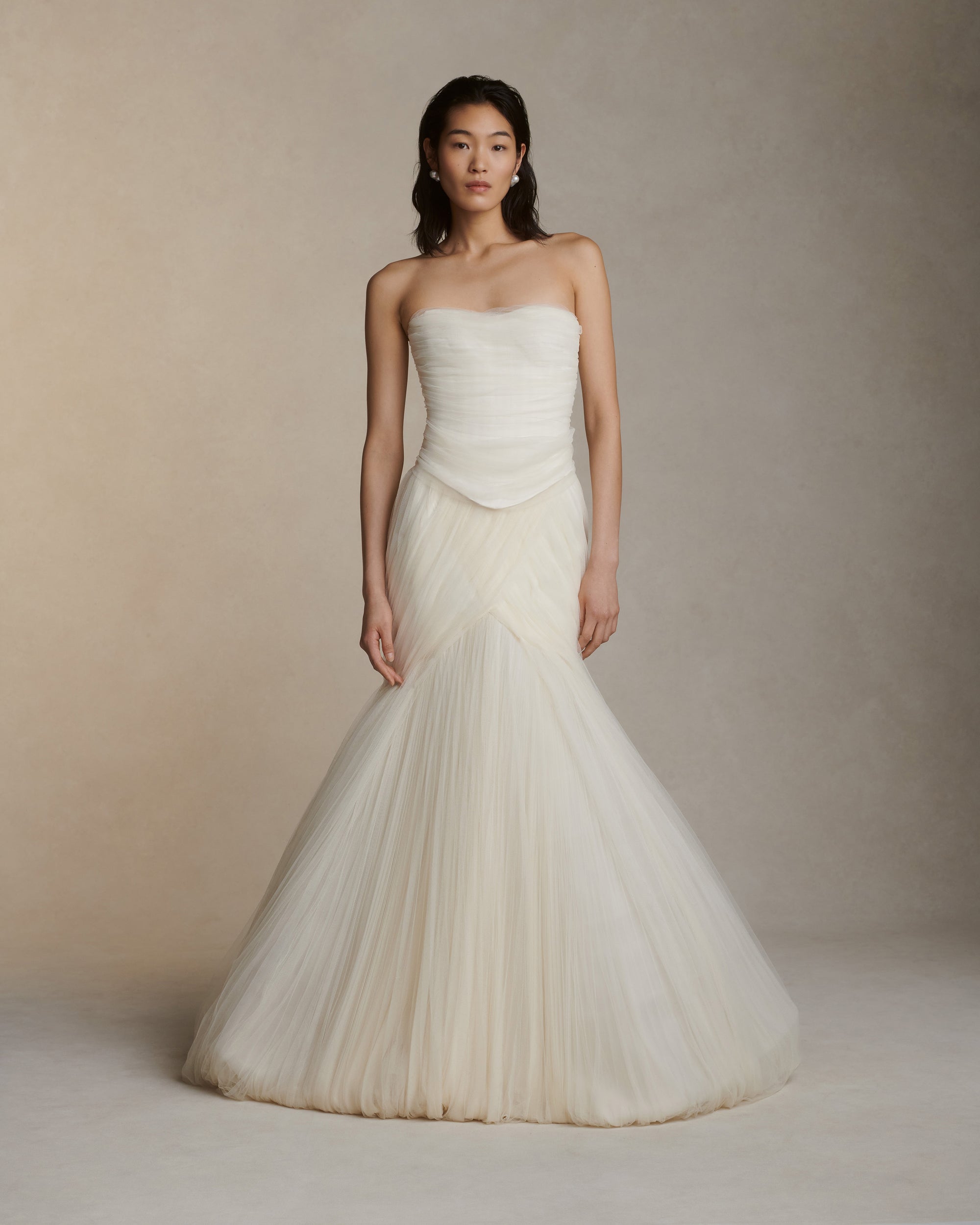 Structured corset top with dipped waist and layered soft tulle draping at front. Exposed organza bustier at back with grosgrain detail. Soft cups, internal grosgrain waist belt and invisible center back zip closure.Styled with Jack pant &amp; Jacqueline skirt 