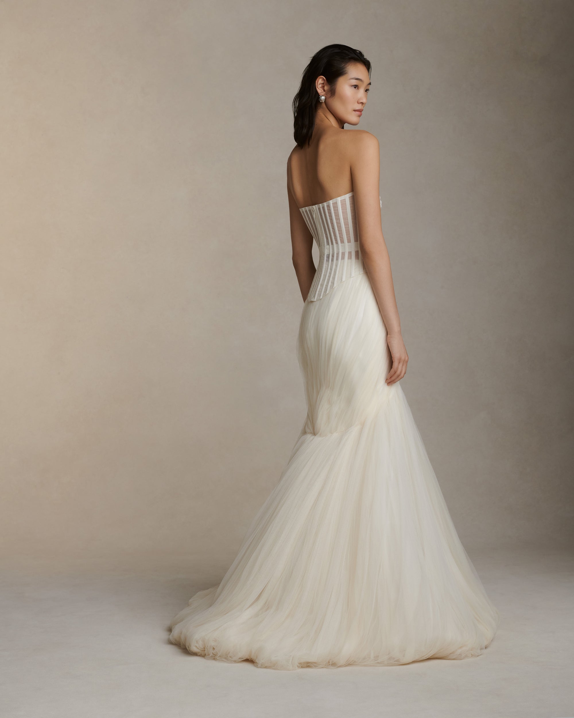 Sunburst pleated and draped soft tulle skirt with bubbled hem. Center back zip.Styled with Milo bustier
